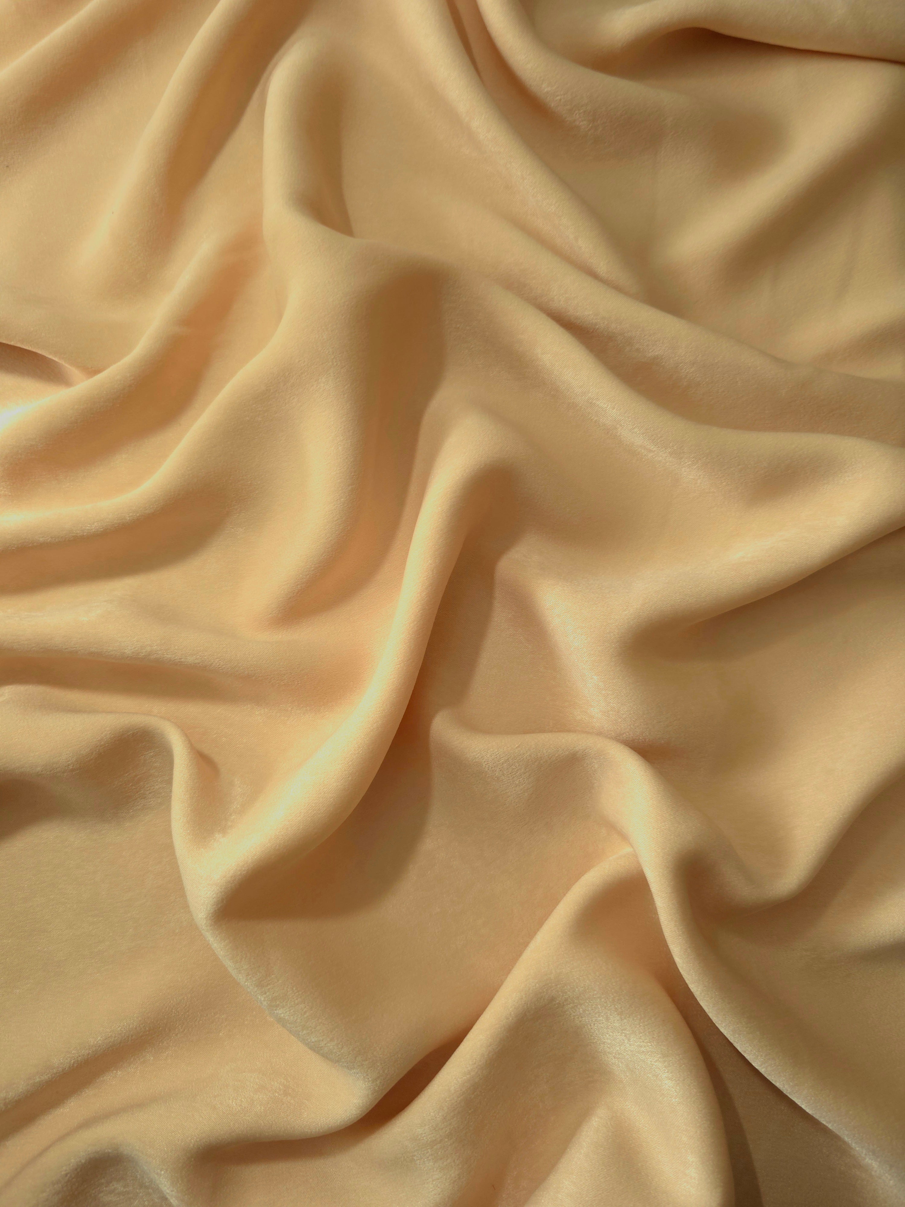 Milano matte sandwashed silky fabric in Golden Wheat, shown as a soft textile for dresses, blouses and apparel