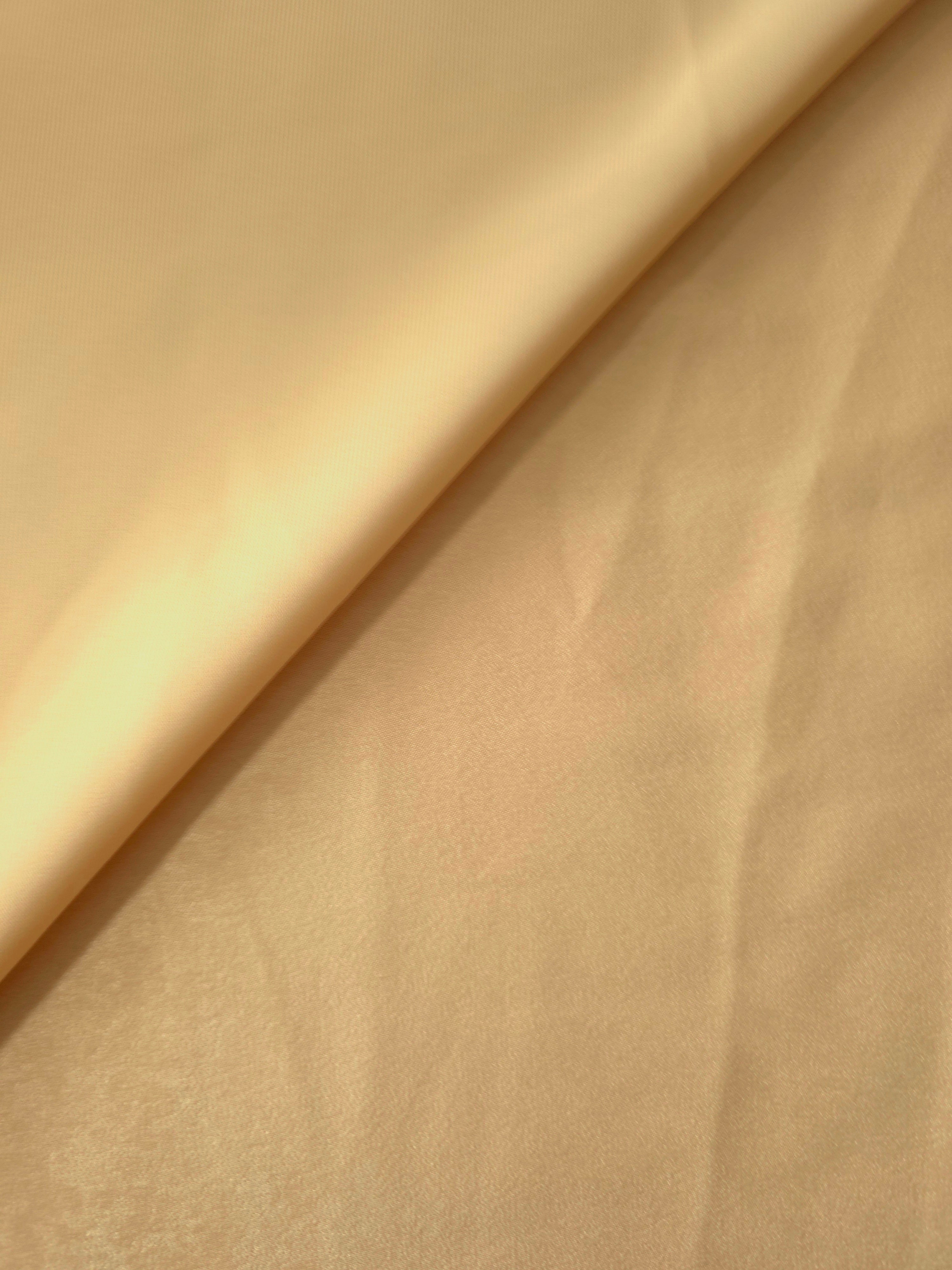 Close-up of Golden Wheat Milano sandwashed silky fabric showing its smooth matte texture and soft surface