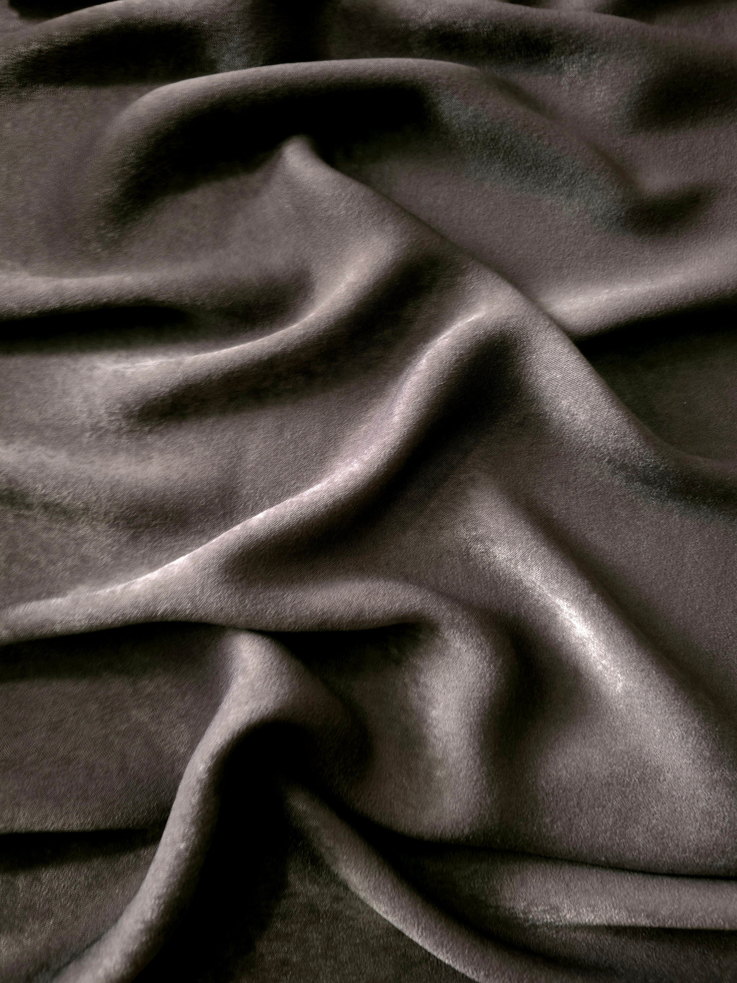 Close-up of Graphite Taupe Milano sandwashed silky fabric showing its smooth matte texture and soft surface