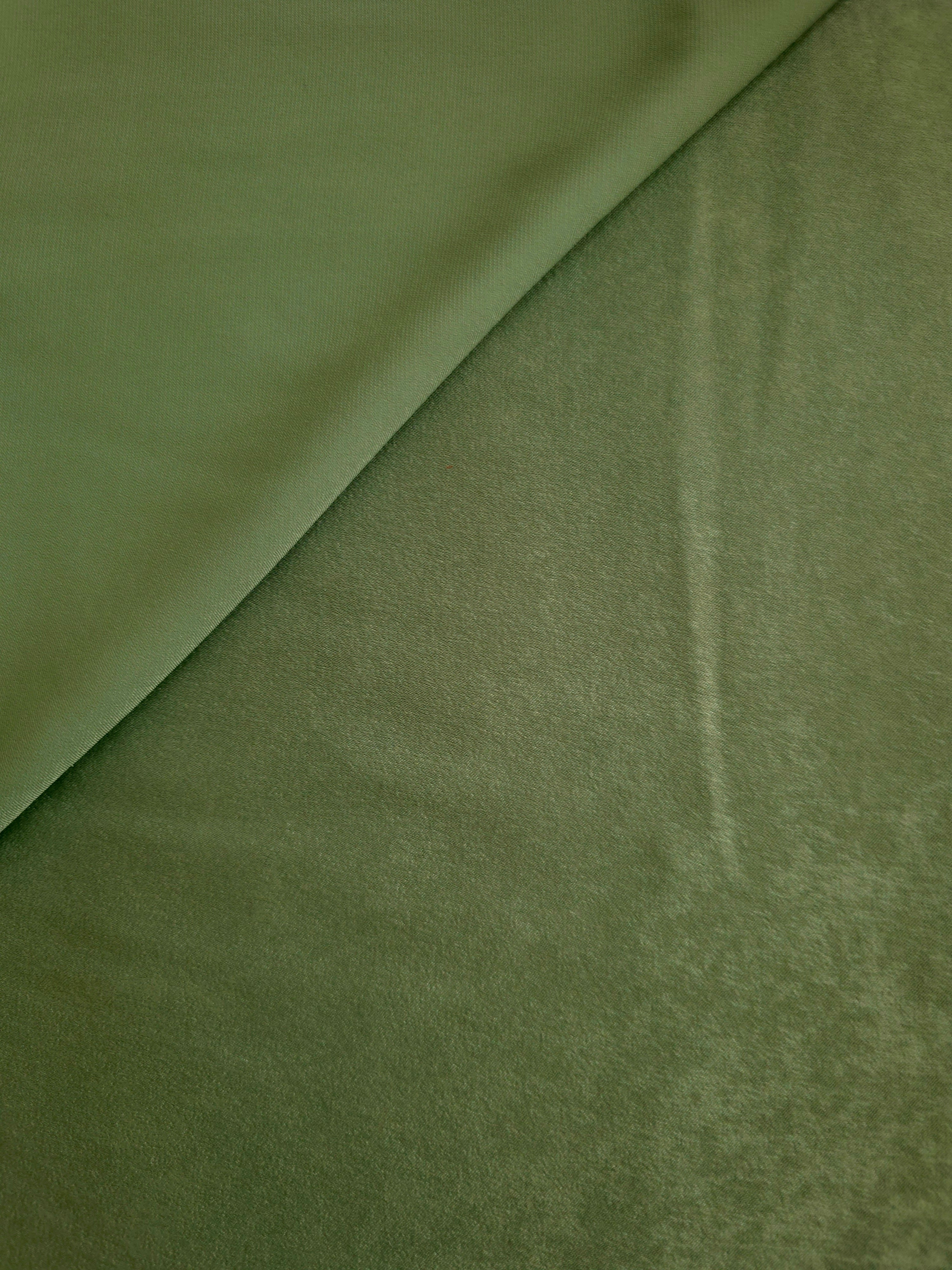 Close-up of Loden Moss Milano sandwashed silky fabric showing its smooth matte texture and soft surface