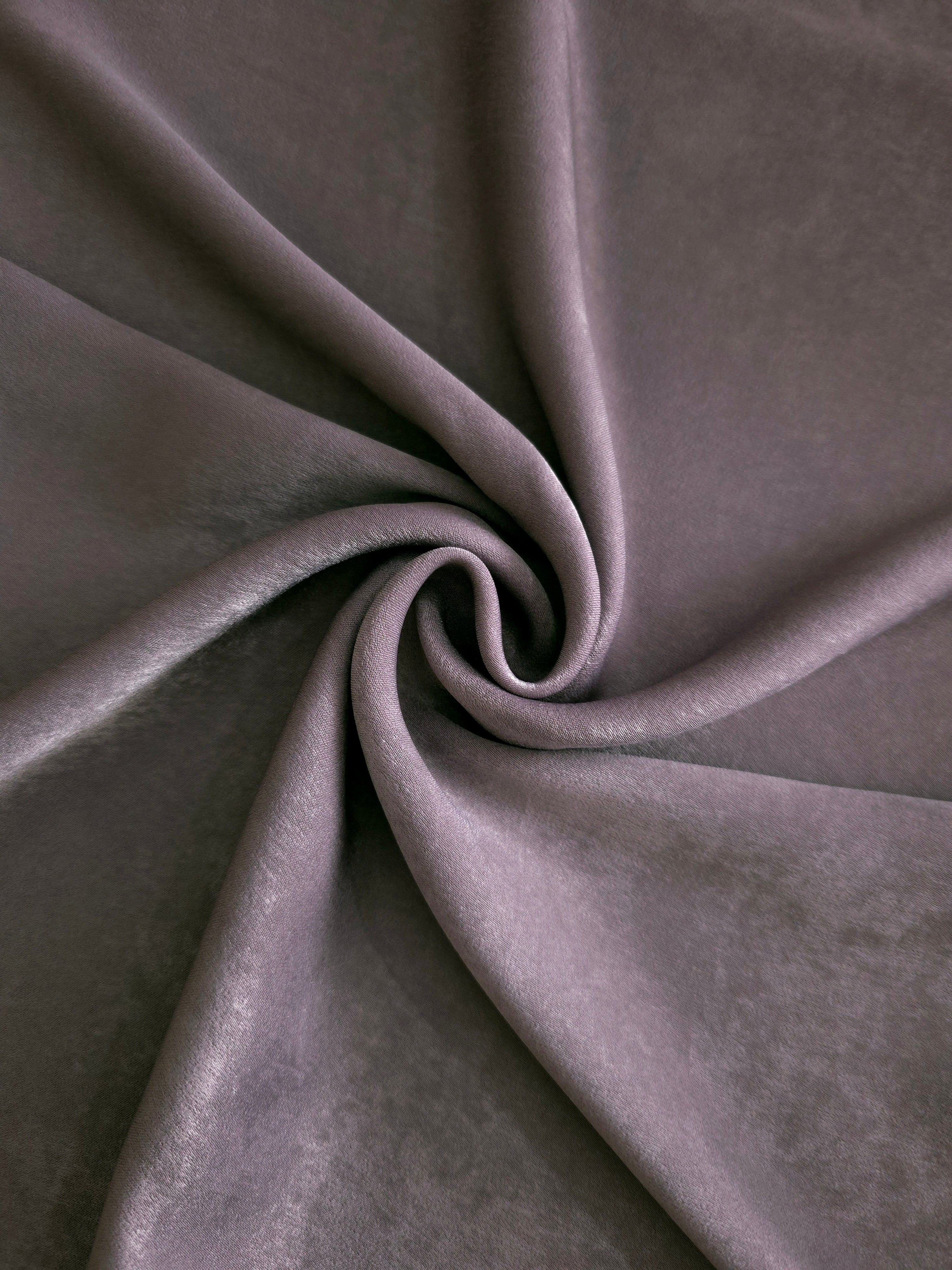 Soft folded detail of Mauve Smoke Milano sandwashed silky fabric highlighting its matte finish and supple hand