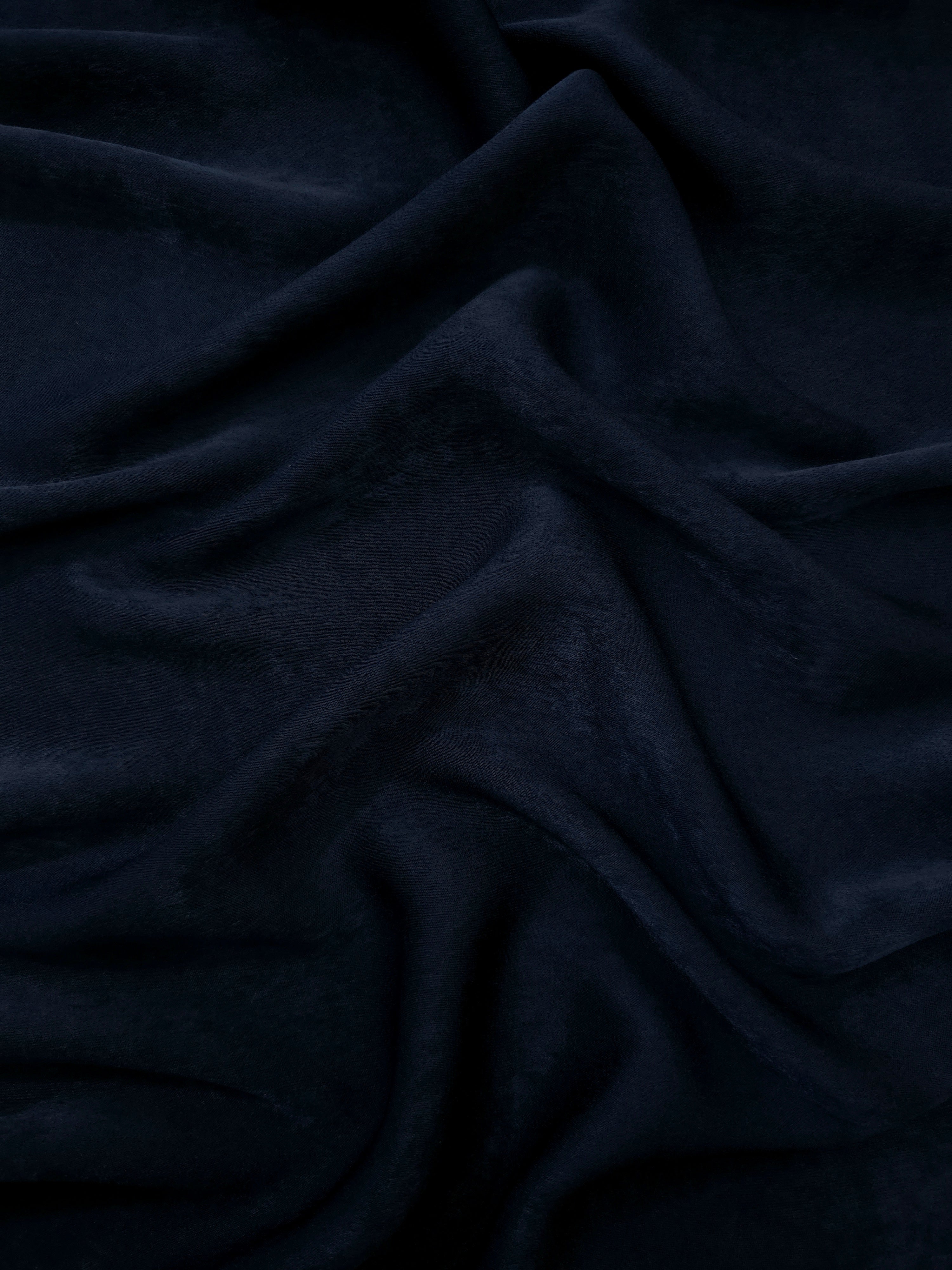 Close-up of Midnight Ink Milano sandwashed silky fabric showing its smooth matte texture and soft surface