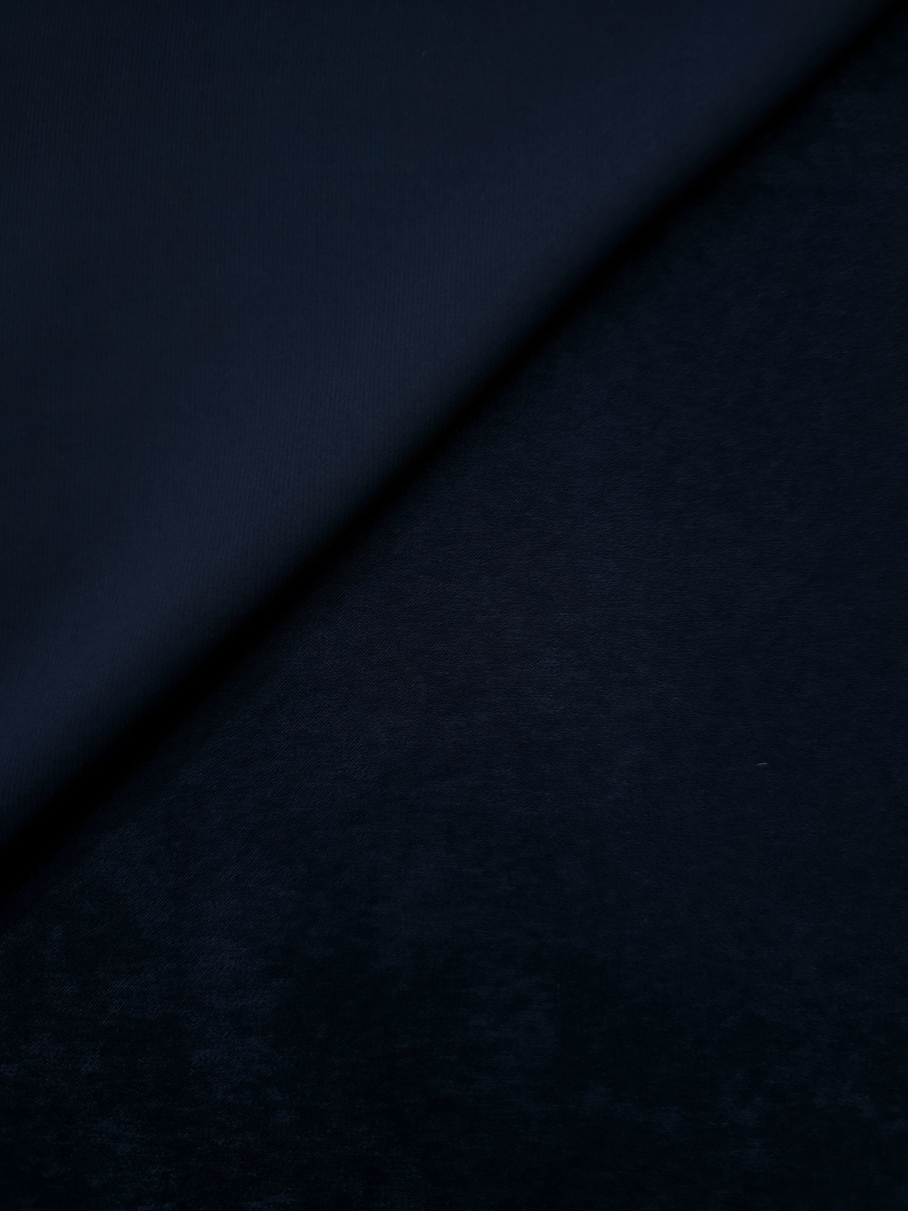 Soft folded detail of Midnight Ink Milano sandwashed silky fabric highlighting its matte finish and supple hand