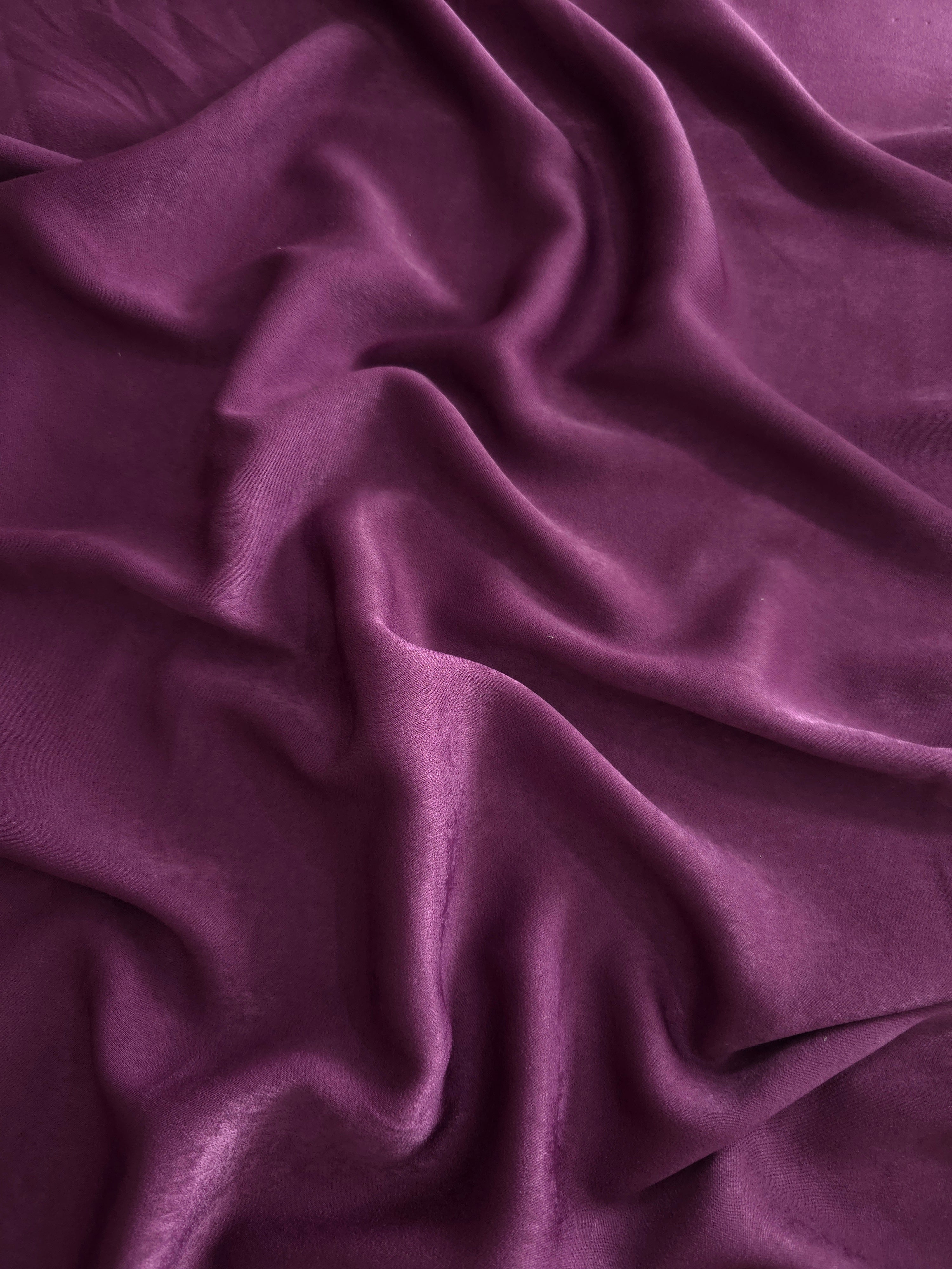 Milano matte sandwashed silky fabric in Mulberry Plum, shown as a soft textile for dresses, blouses and apparel