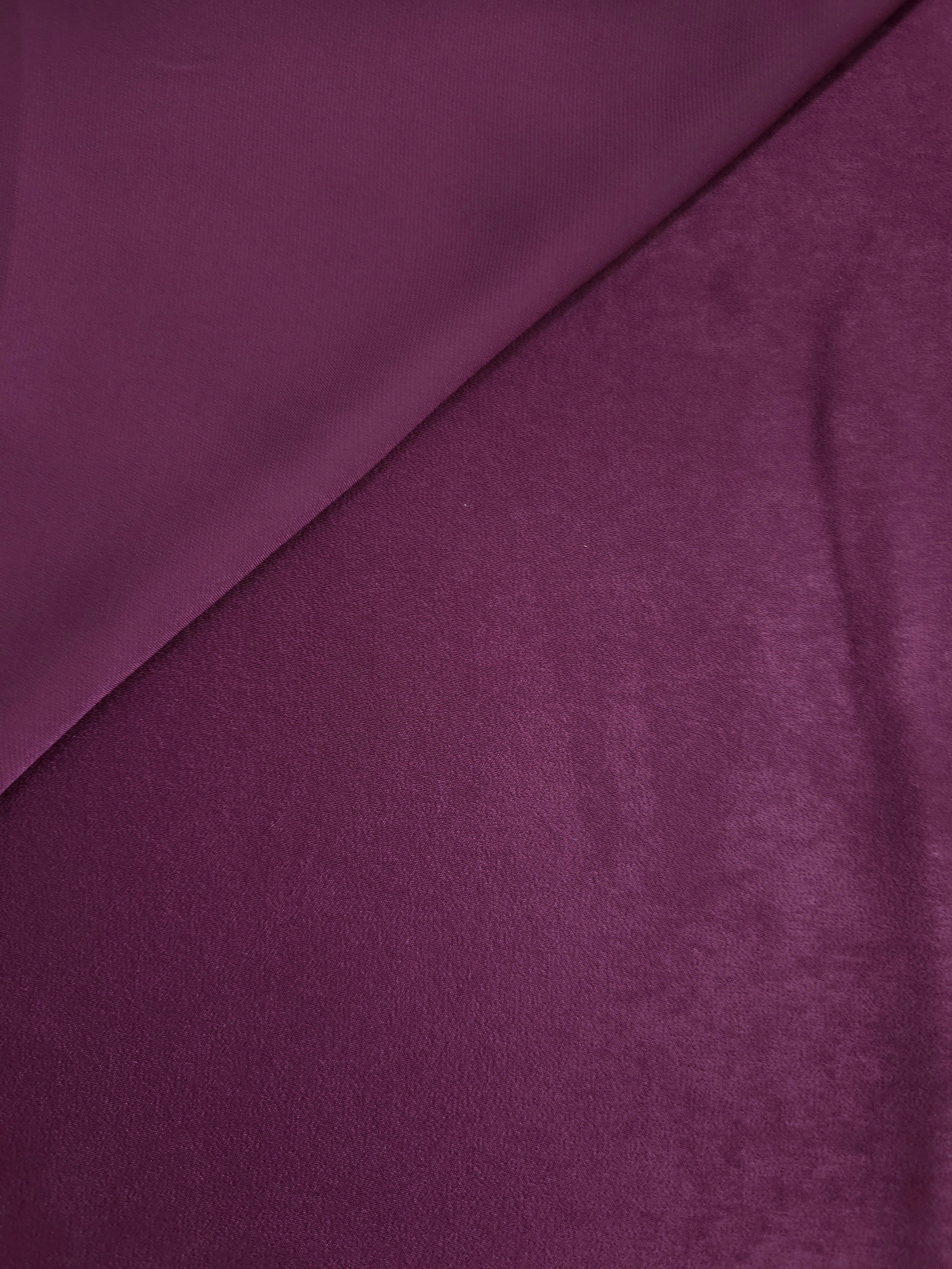 Close-up of Mulberry Plum Milano sandwashed silky fabric showing its smooth matte texture and soft surface