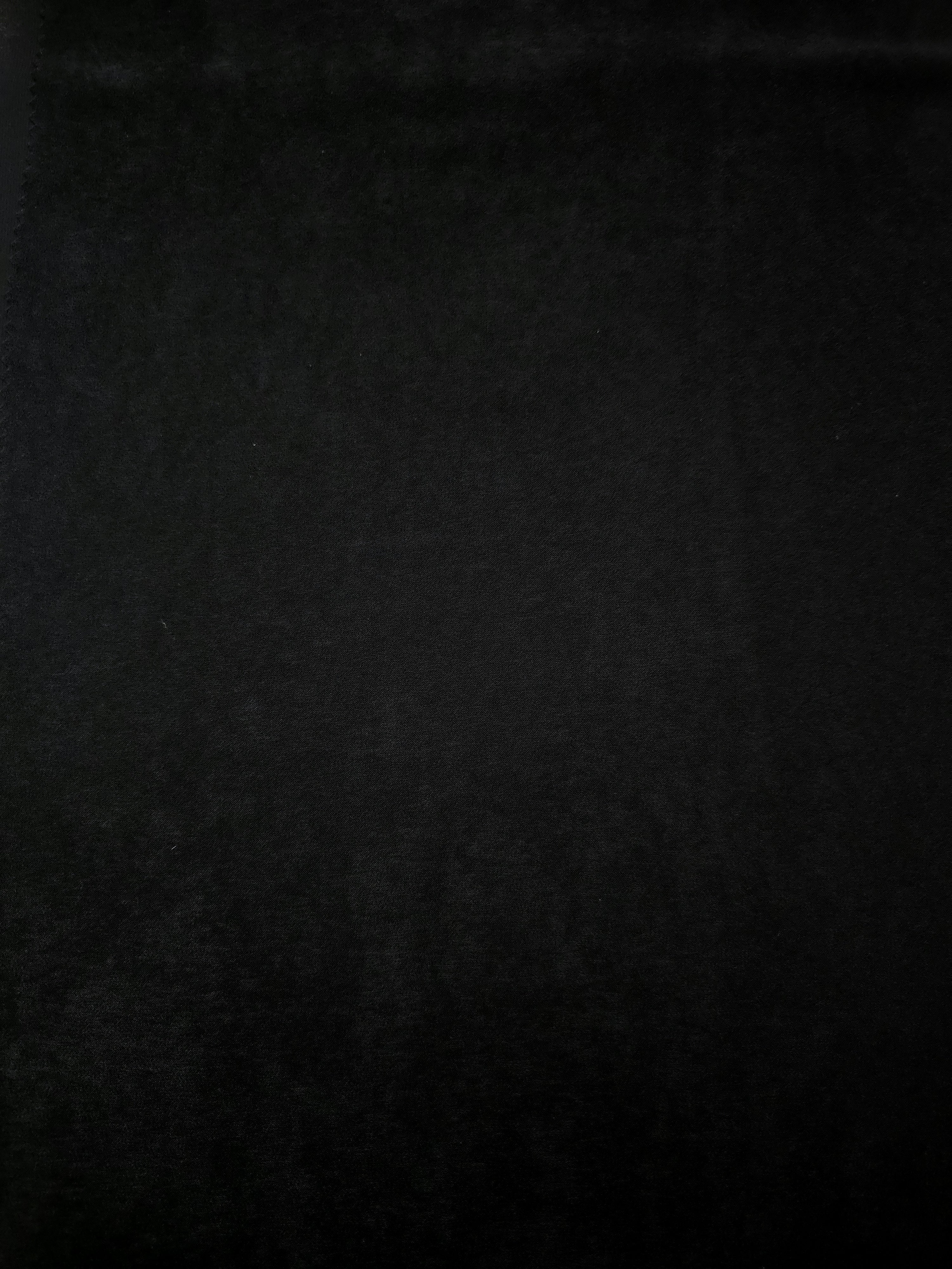 Obsidian Black Milano sandwashed silky fabric with a soft fluid drape and smooth flowing folds
