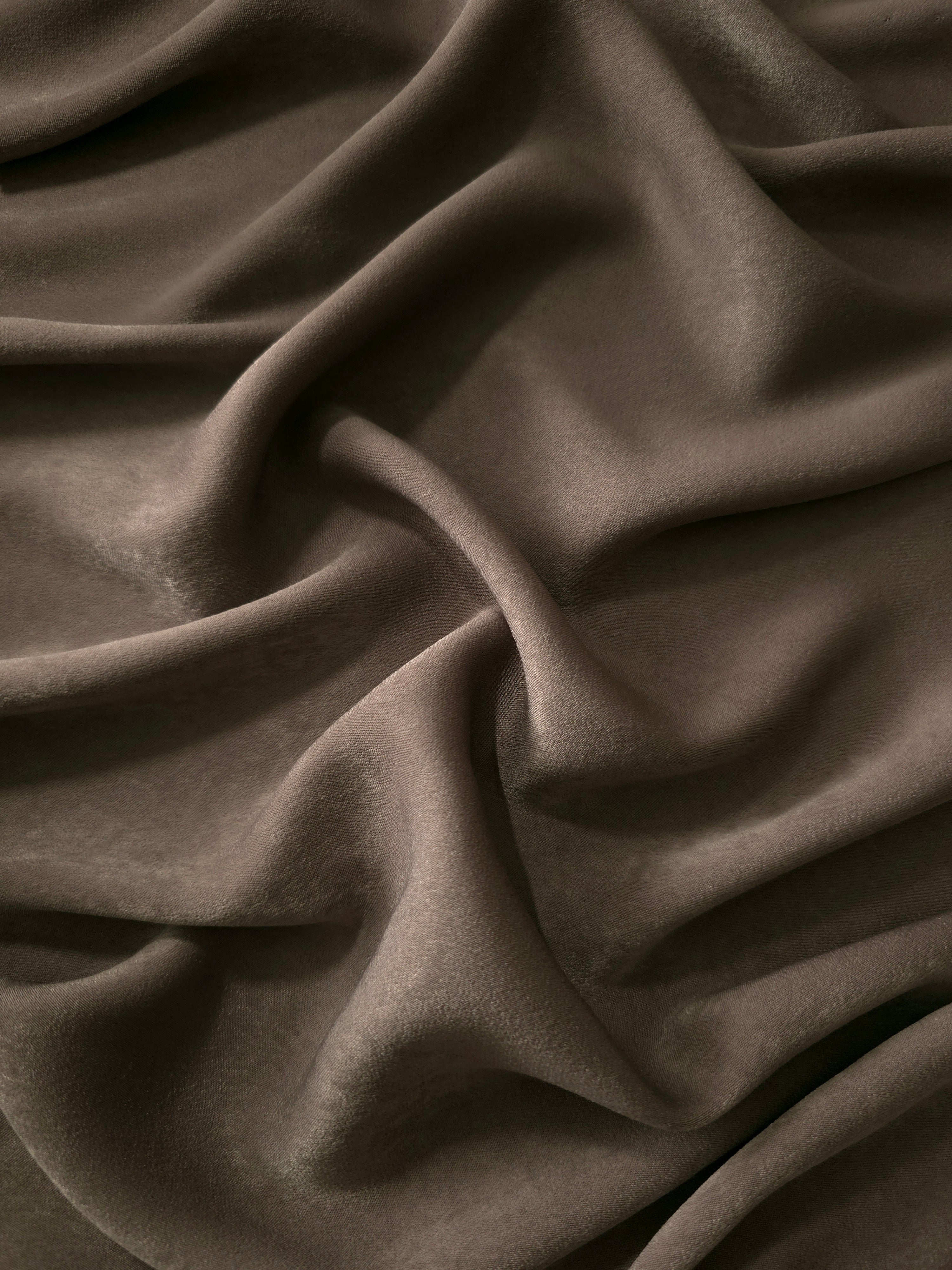 Milano matte sandwashed silky fabric in Olive Walnut, shown as a soft textile for dresses, blouses and apparel