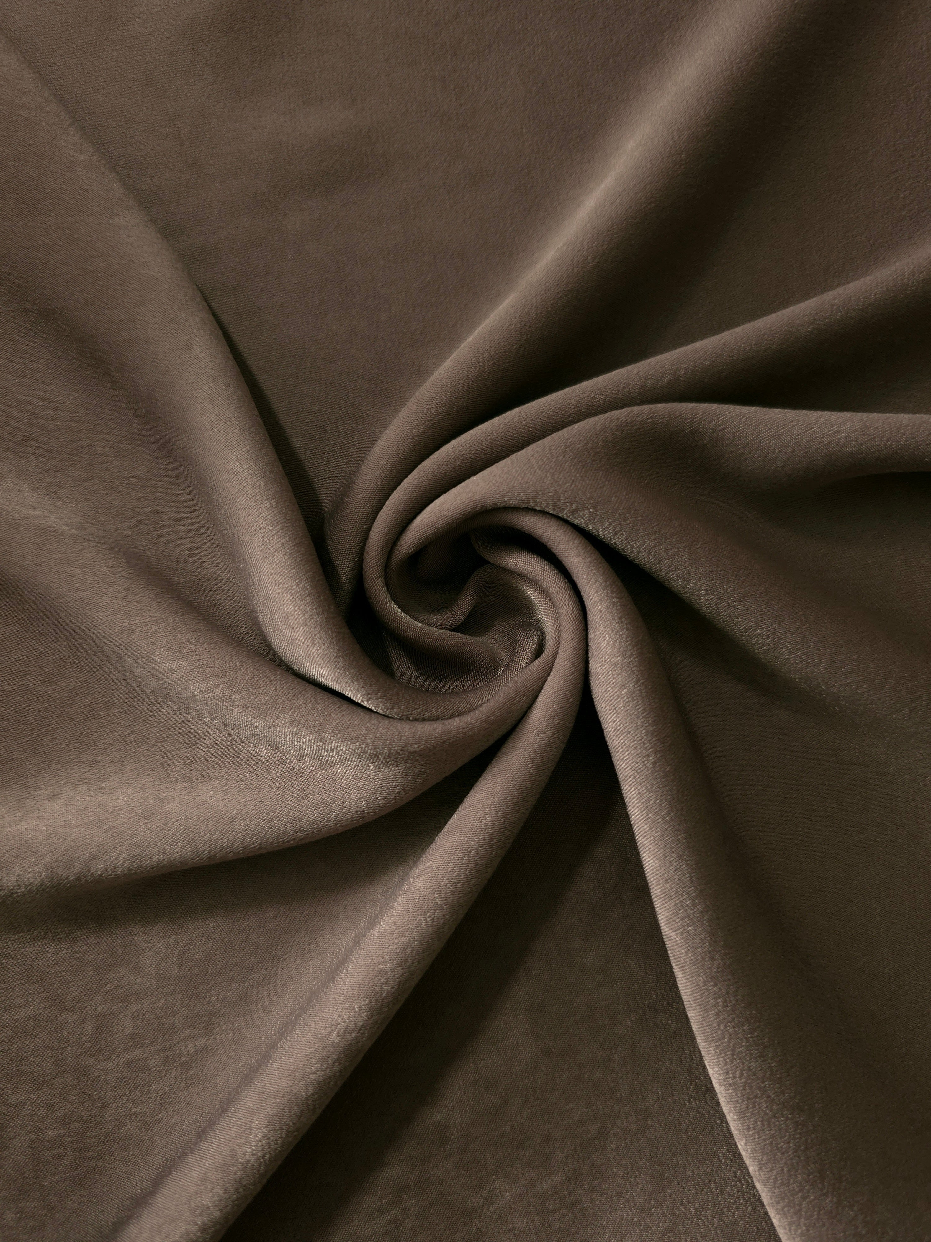 Soft folded detail of Olive Walnut Milano sandwashed silky fabric highlighting its matte finish and supple hand