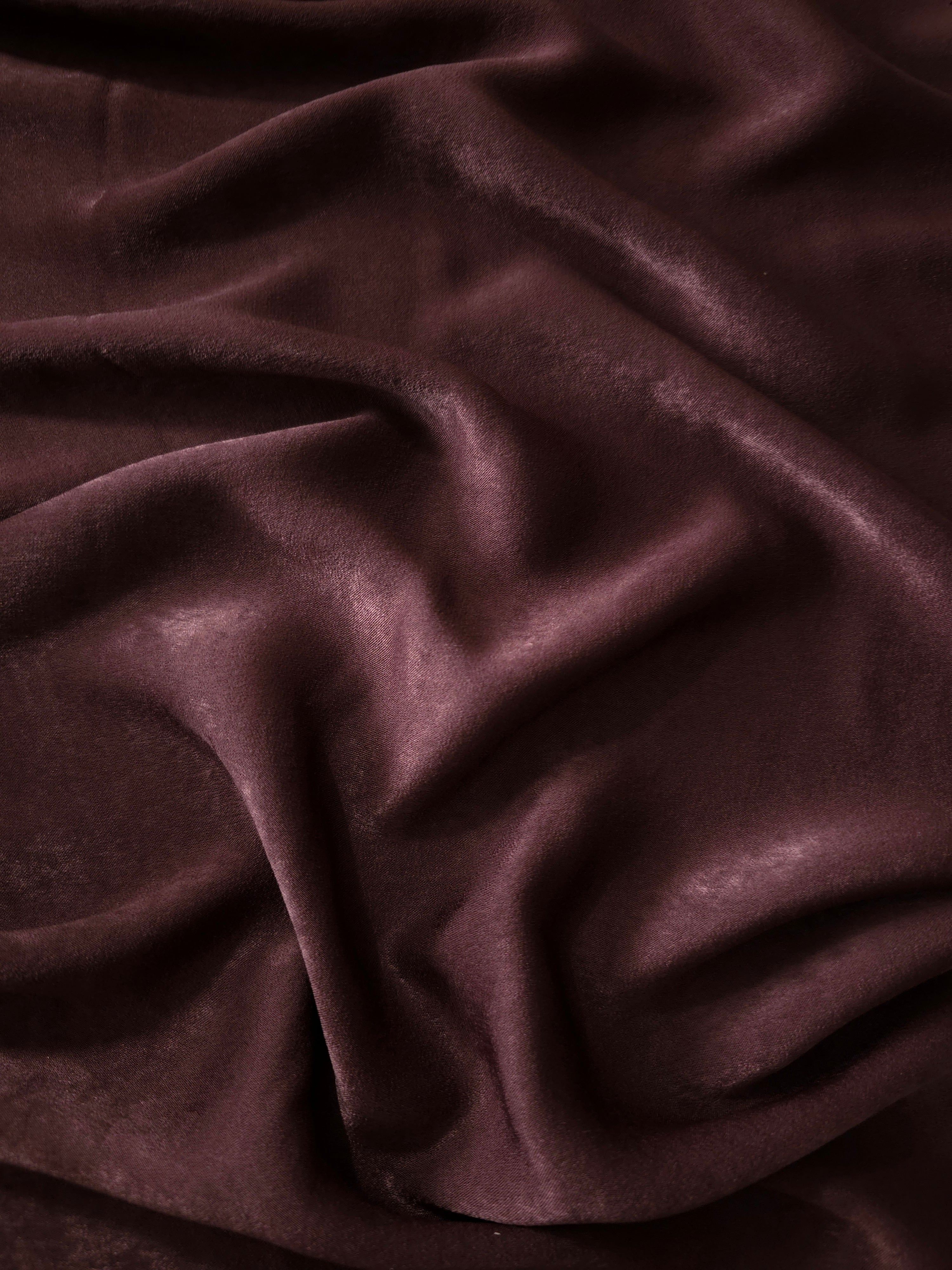 Milano matte sandwashed silky fabric in Oxblood Mahogany, shown as a soft textile for dresses, blouses and apparel