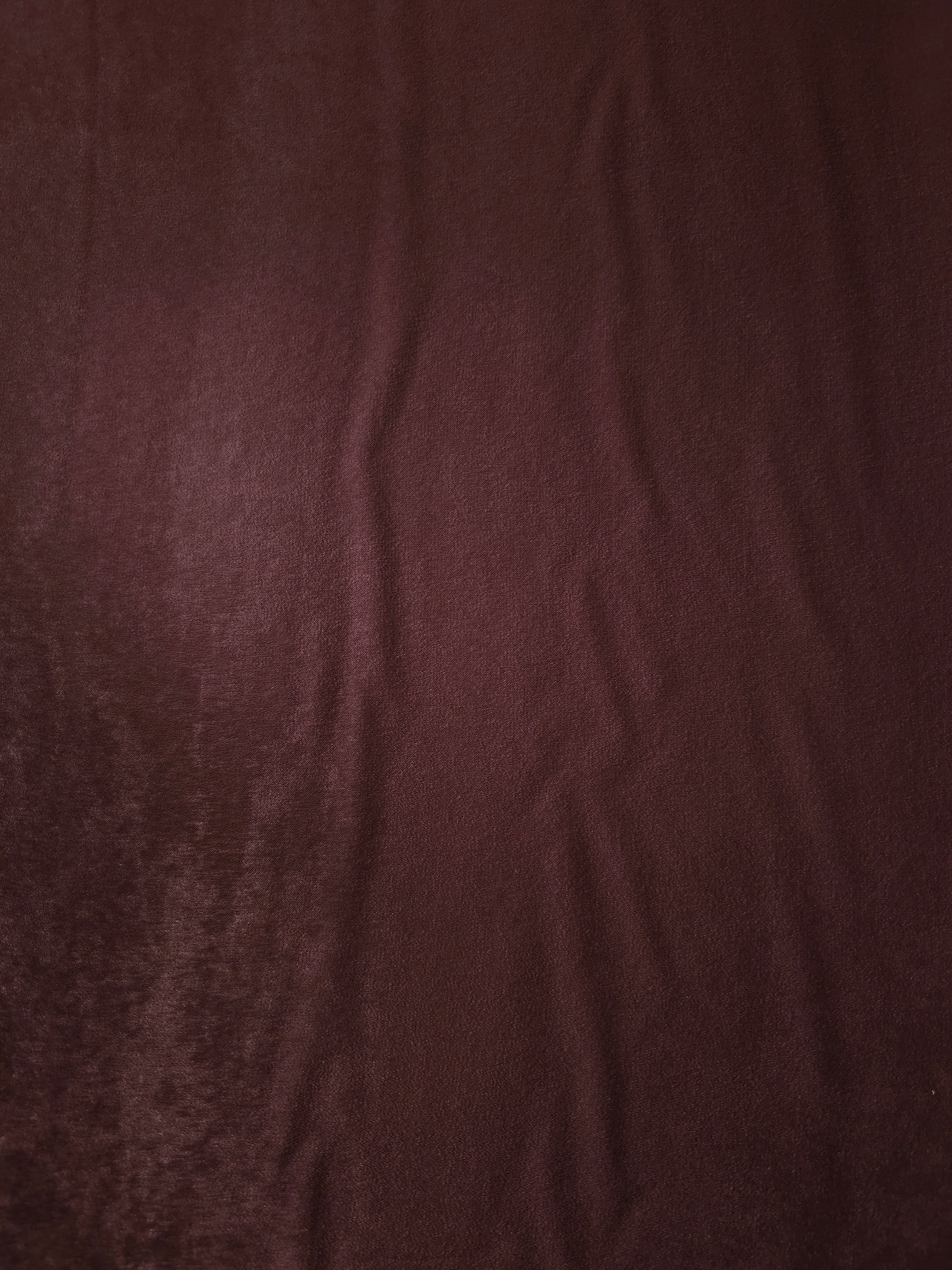 Draped Oxblood Mahogany Milano matte sandwashed silky fabric showing fluid movement for dresses and occasionwear