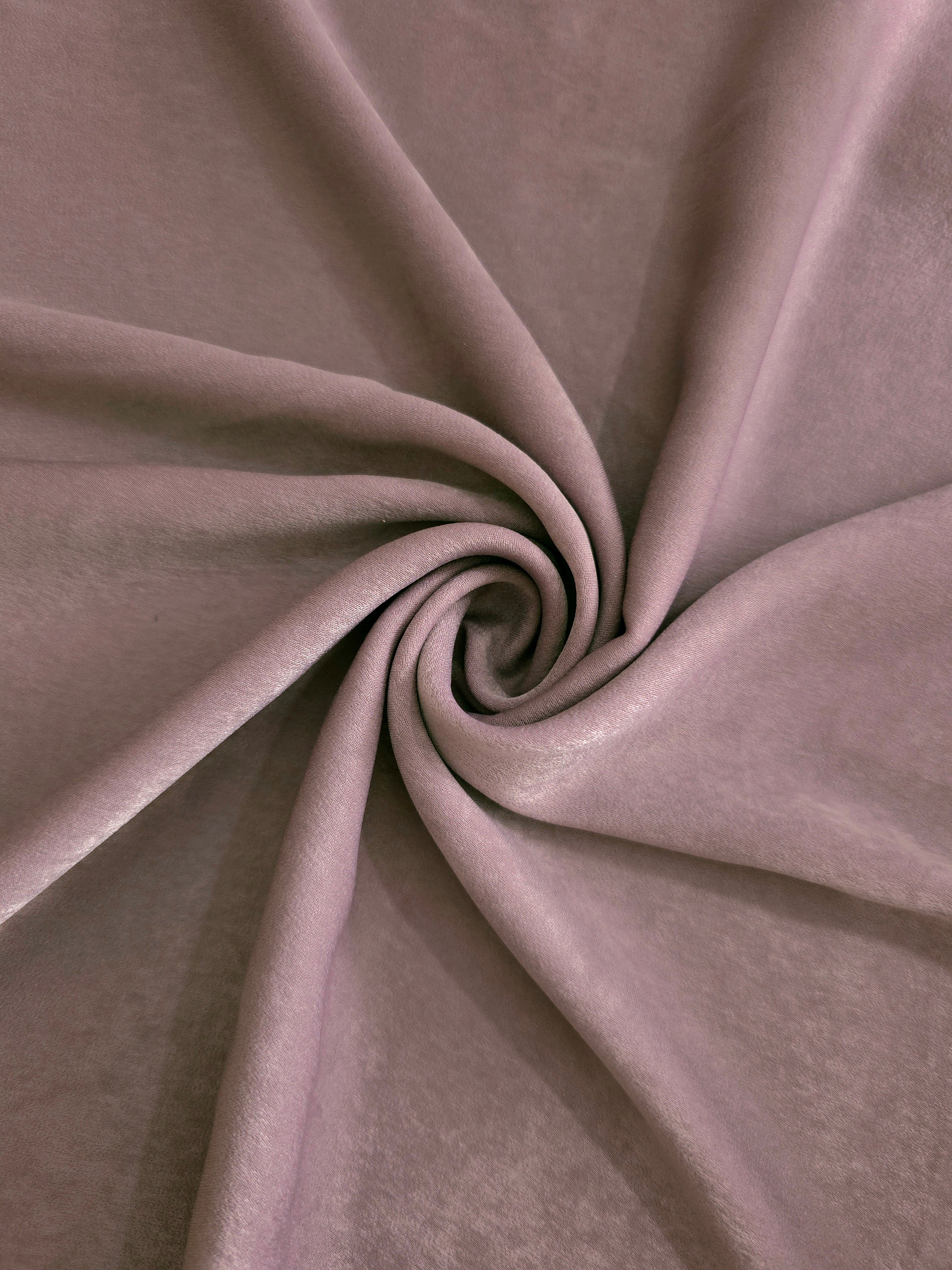 Soft folded detail of Rose Mushroom Milano sandwashed silky fabric highlighting its matte finish and supple hand