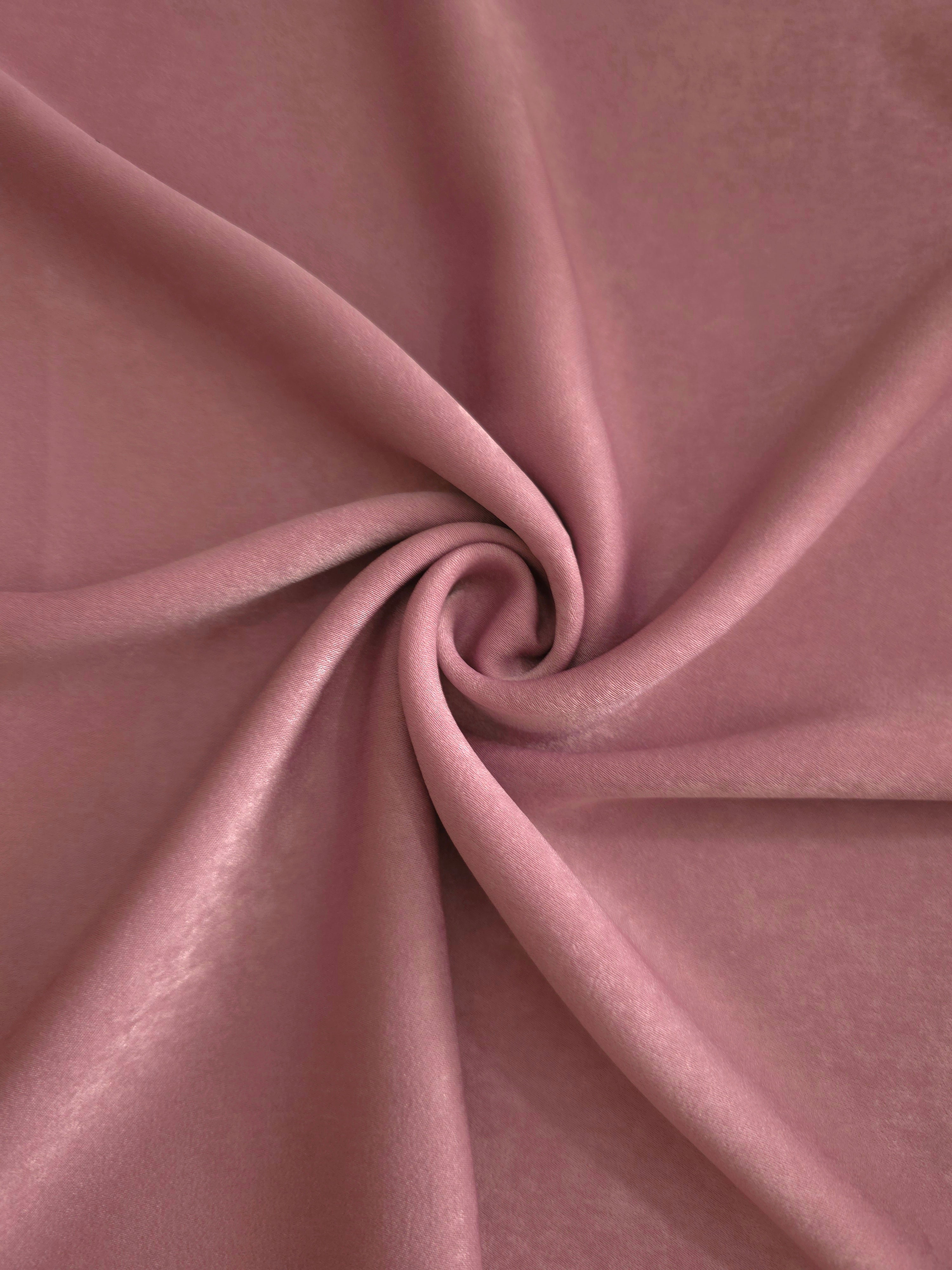 Soft folded detail of Rosewood Mauve Milano sandwashed silky fabric highlighting its matte finish and supple hand