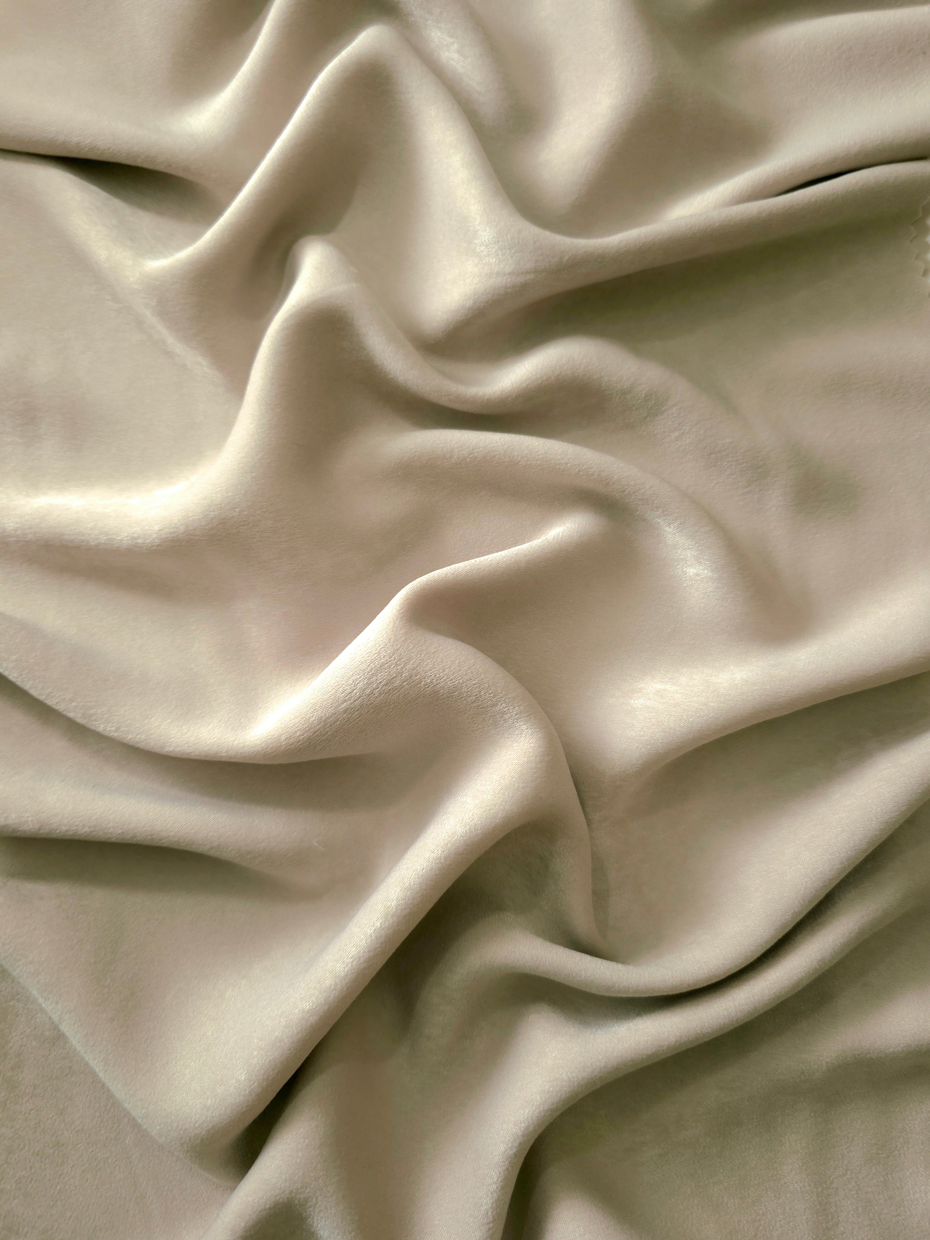 Milano matte sandwashed silky fabric in Warm Greige, shown as a soft textile for dresses, blouses and apparel