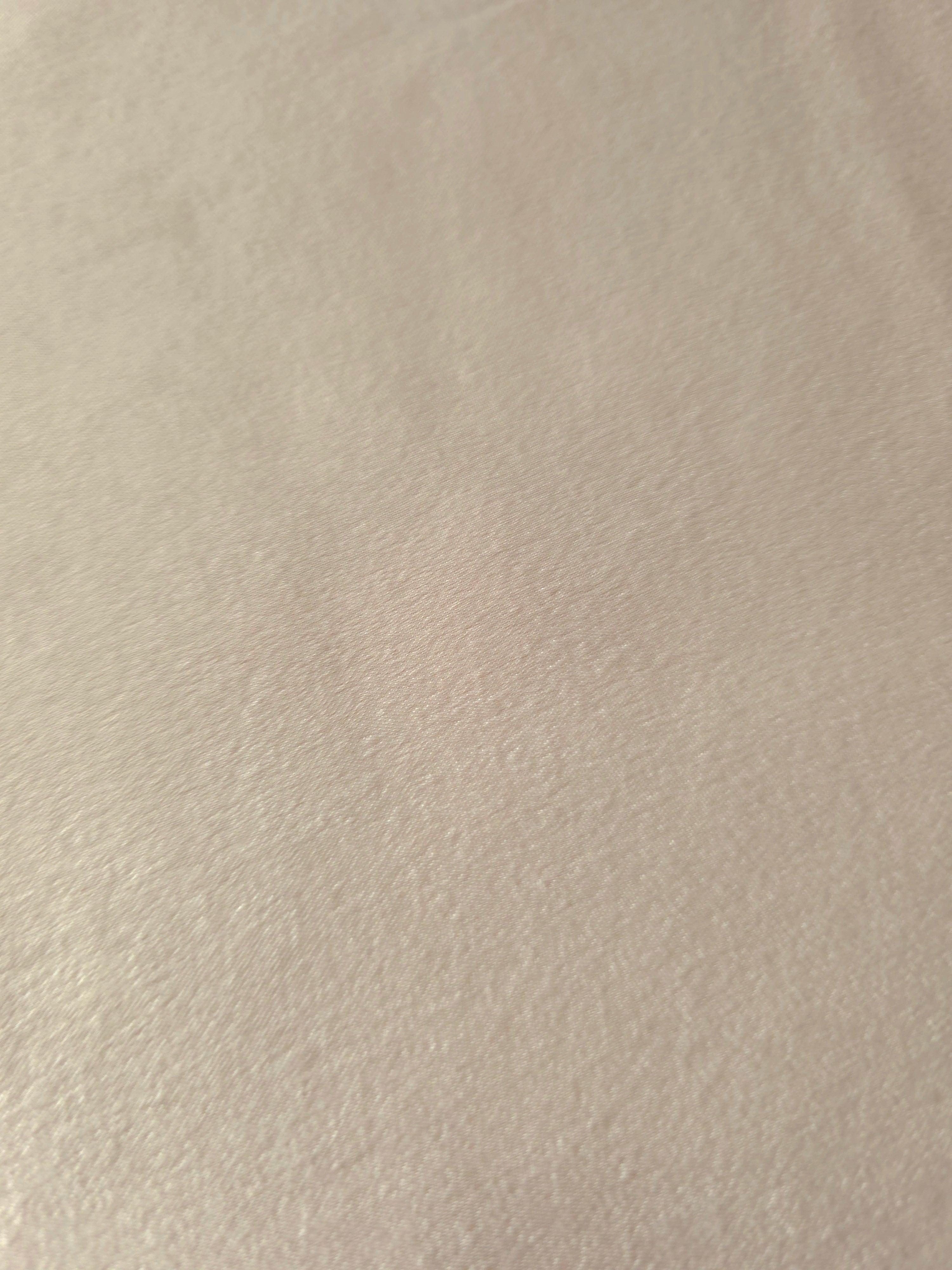 Close-up of Warm Greige Milano sandwashed silky fabric showing its smooth matte texture and soft surface