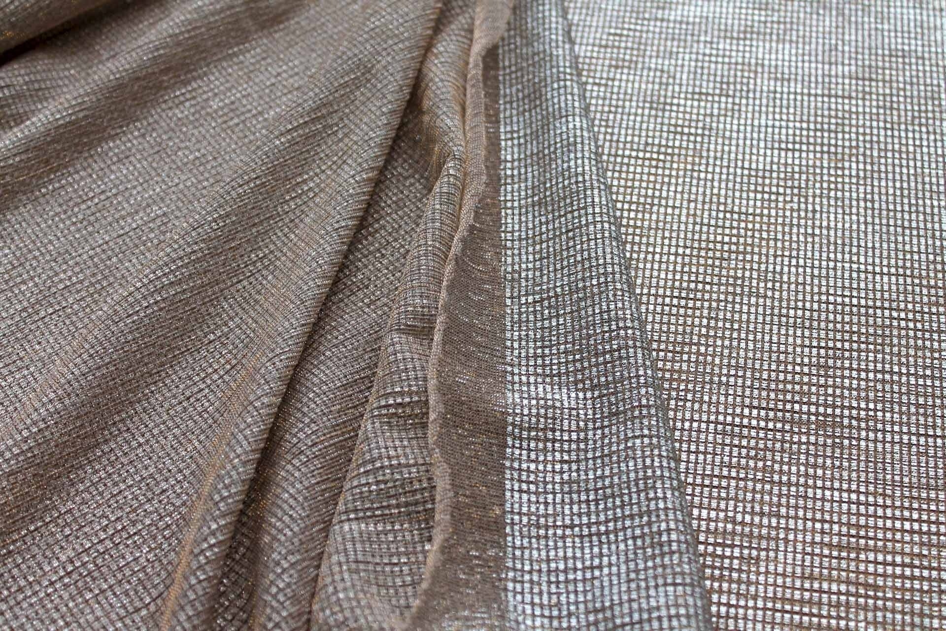 Moonlight gold sheer shimmer stretch tulle fabric showing silver foil reflection under light