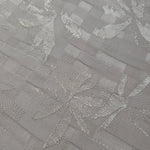 Close-up of flower brick jacquard showing square-weave texture.