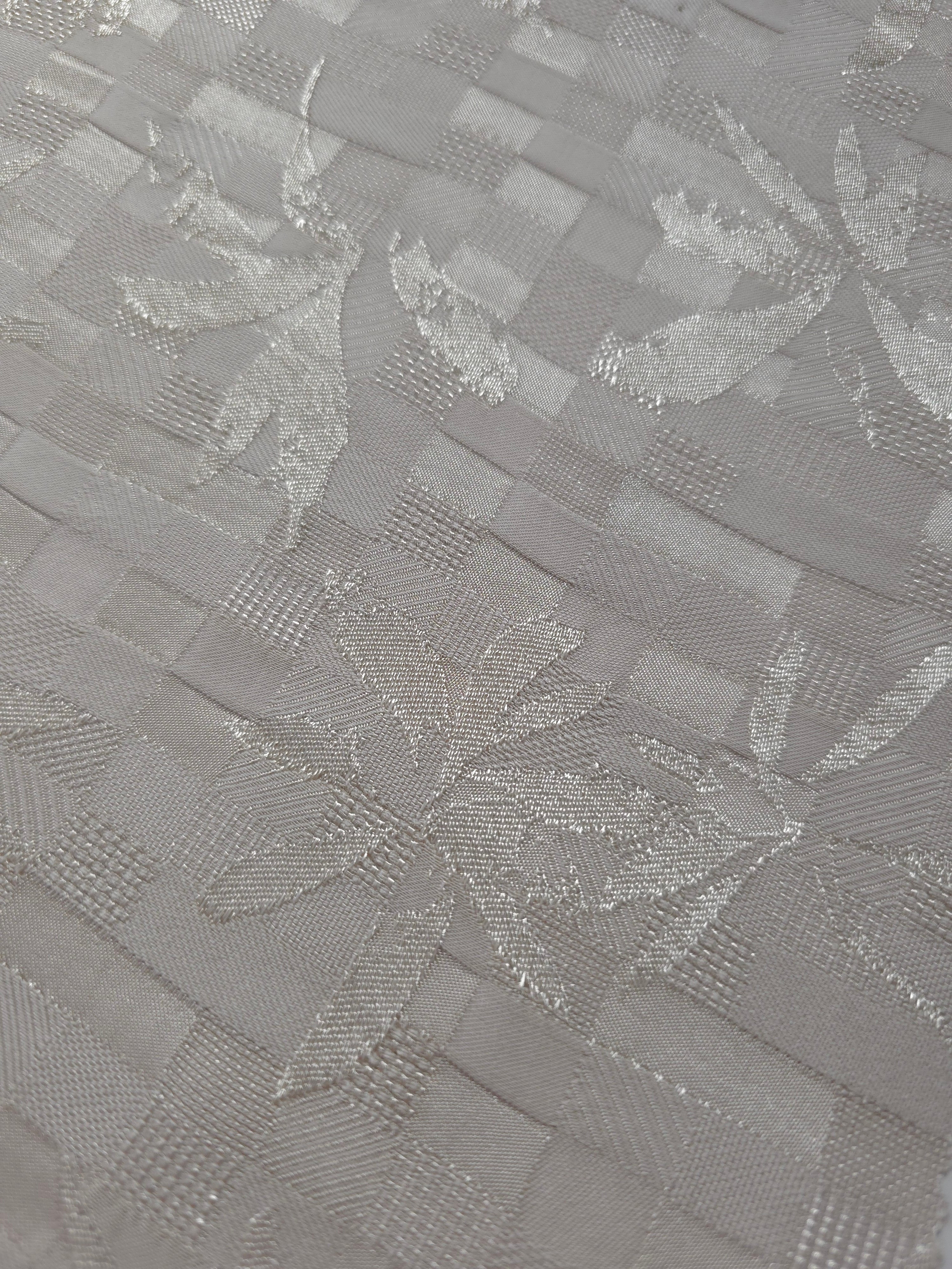 Close-up of flower brick jacquard showing square-weave texture.
