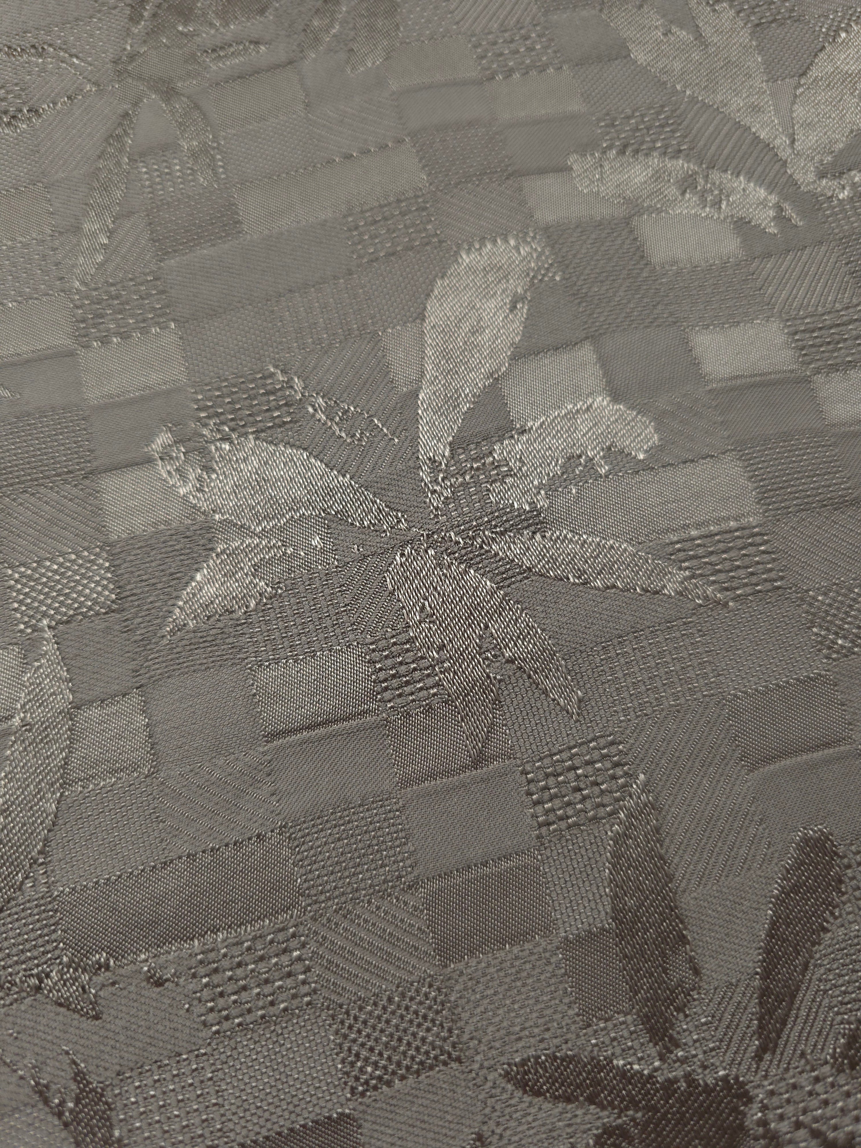 Close-up of tonal flower brick jacquard showing floral square-weave surface.