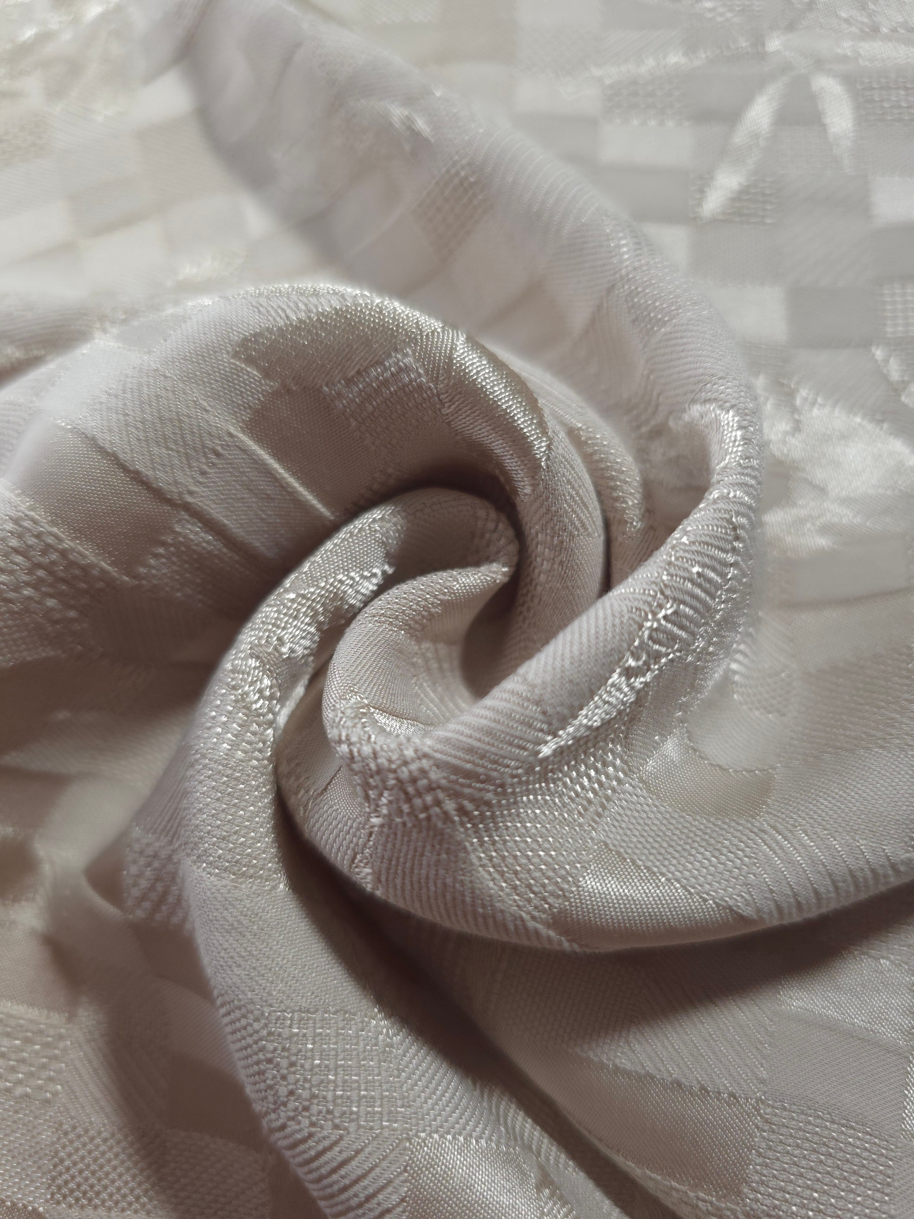 Close drape of flower brick jacquard showing fold detail and soft sheen.