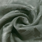 Close drape of flower brick jacquard colourway showing woven fold detail.