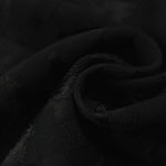 Close drape of flower brick jacquard in another colourway showing fold detail.