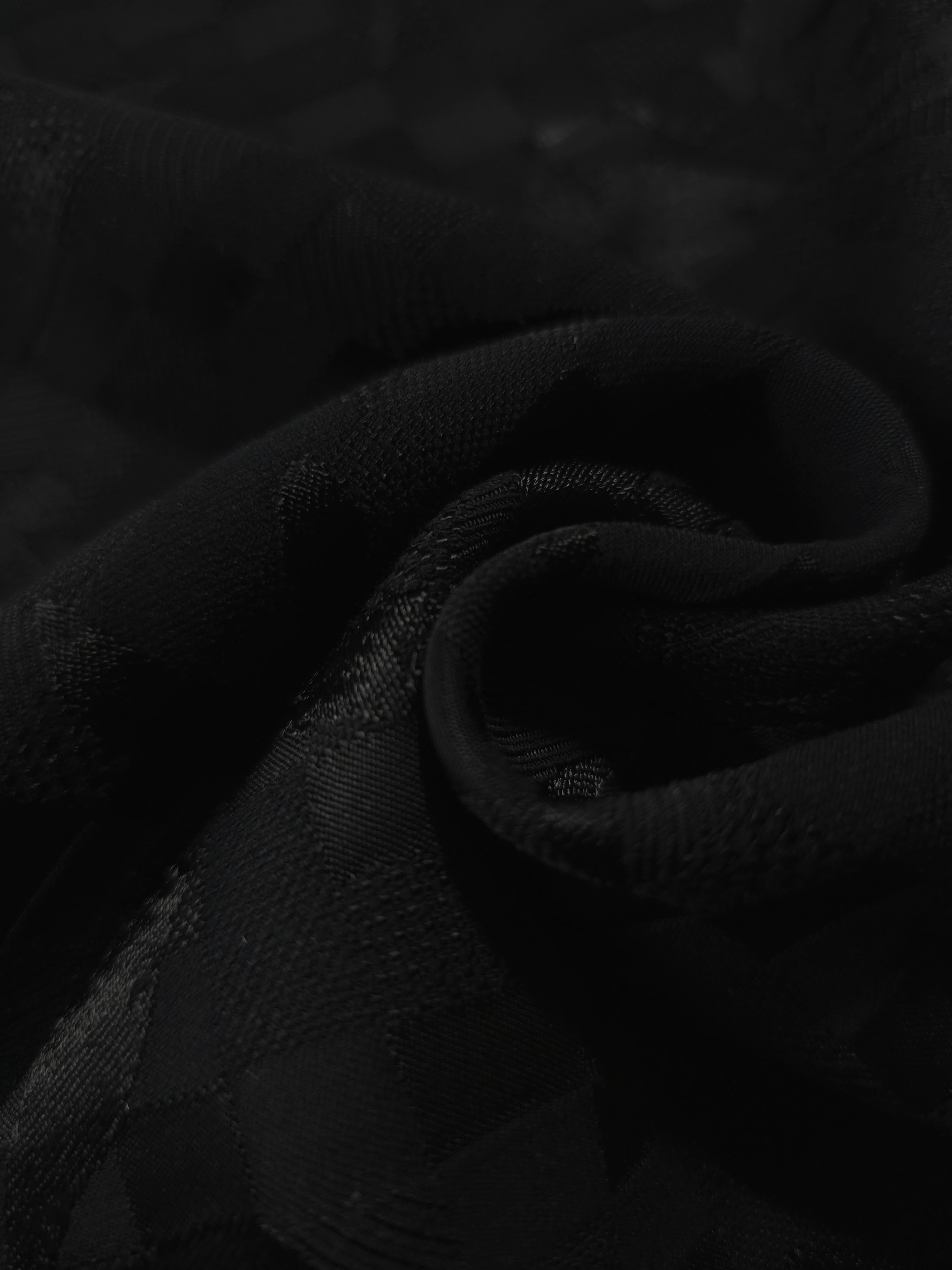 Close drape of flower brick jacquard in another colourway showing fold detail.