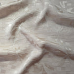 Wave fold of flower brick jacquard showing satin-on-matte floral motif.