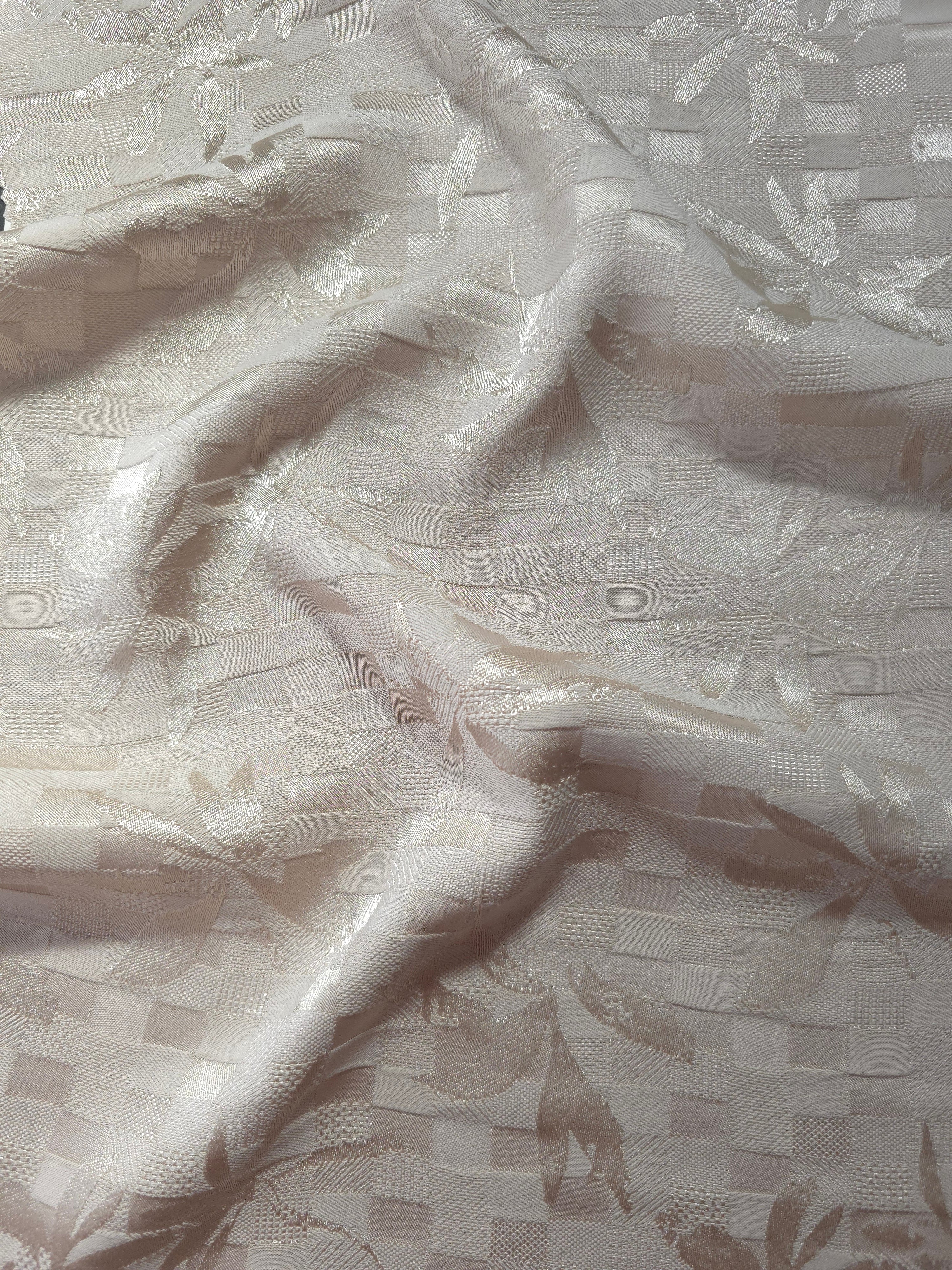 Wave fold of flower brick jacquard showing satin-on-matte floral motif.