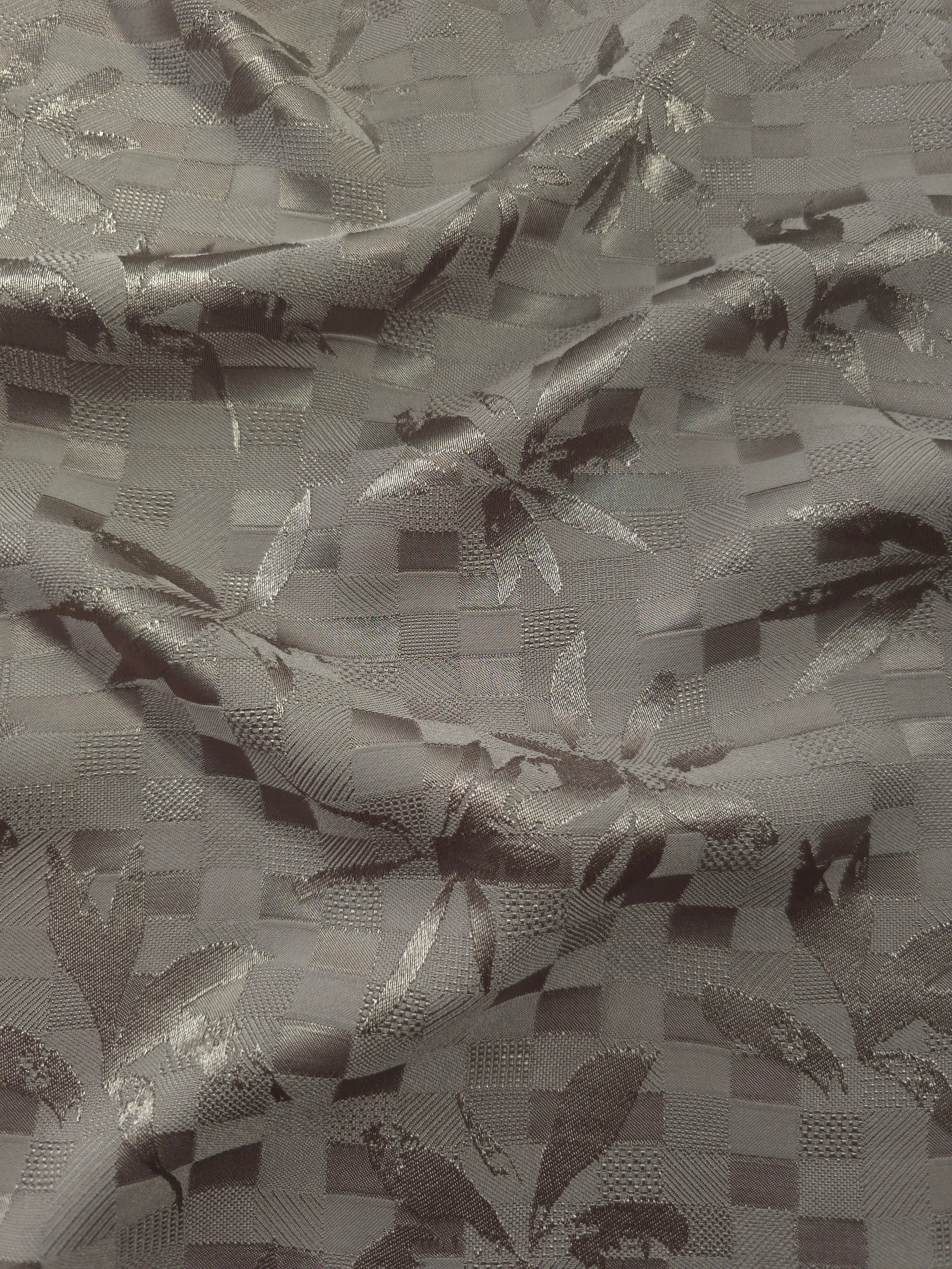 Wave fold of tonal flower brick jacquard showing soft woven sheen.