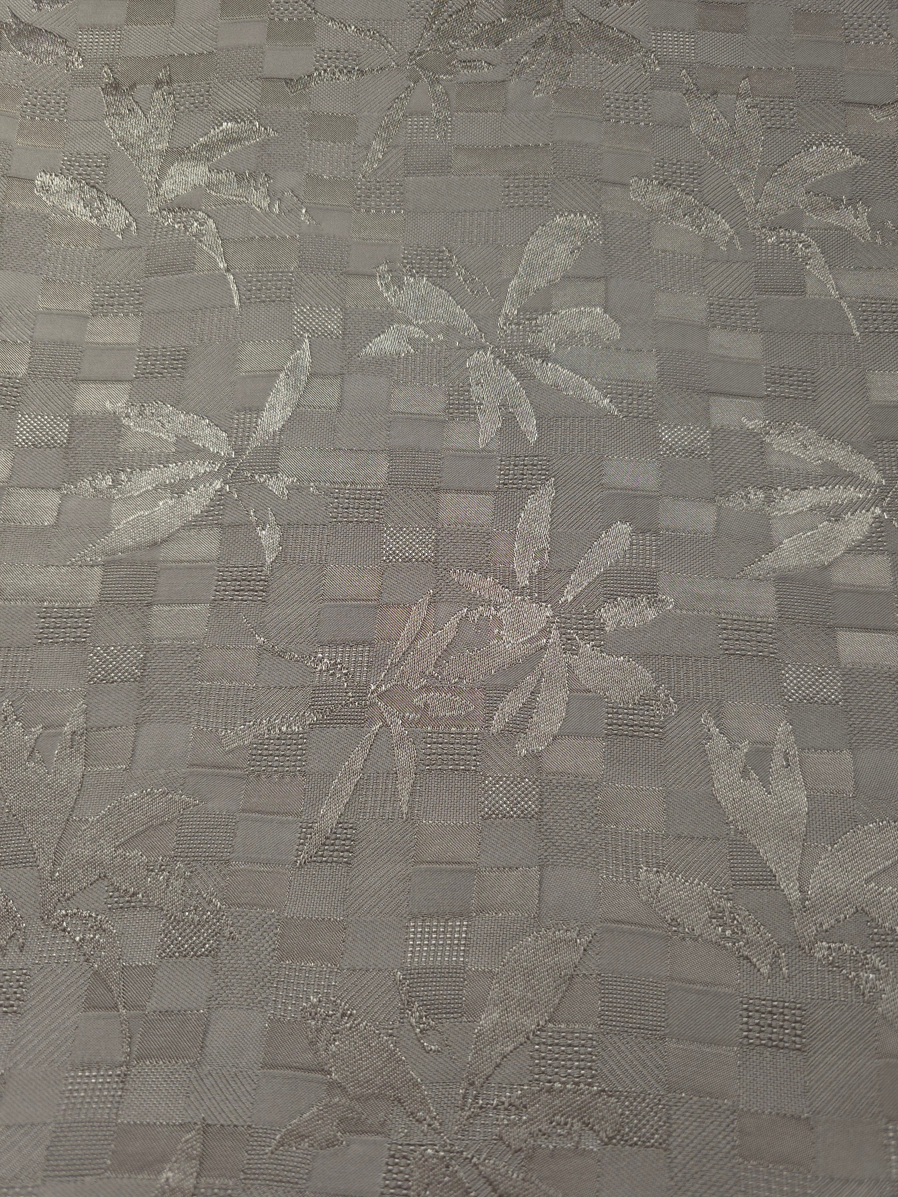 Wide view of tonal flower brick jacquard fabric for garment panels.
