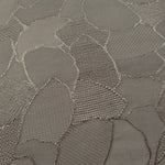 Close-up of tonal mosaic jacquard showing square-weave surface detail.