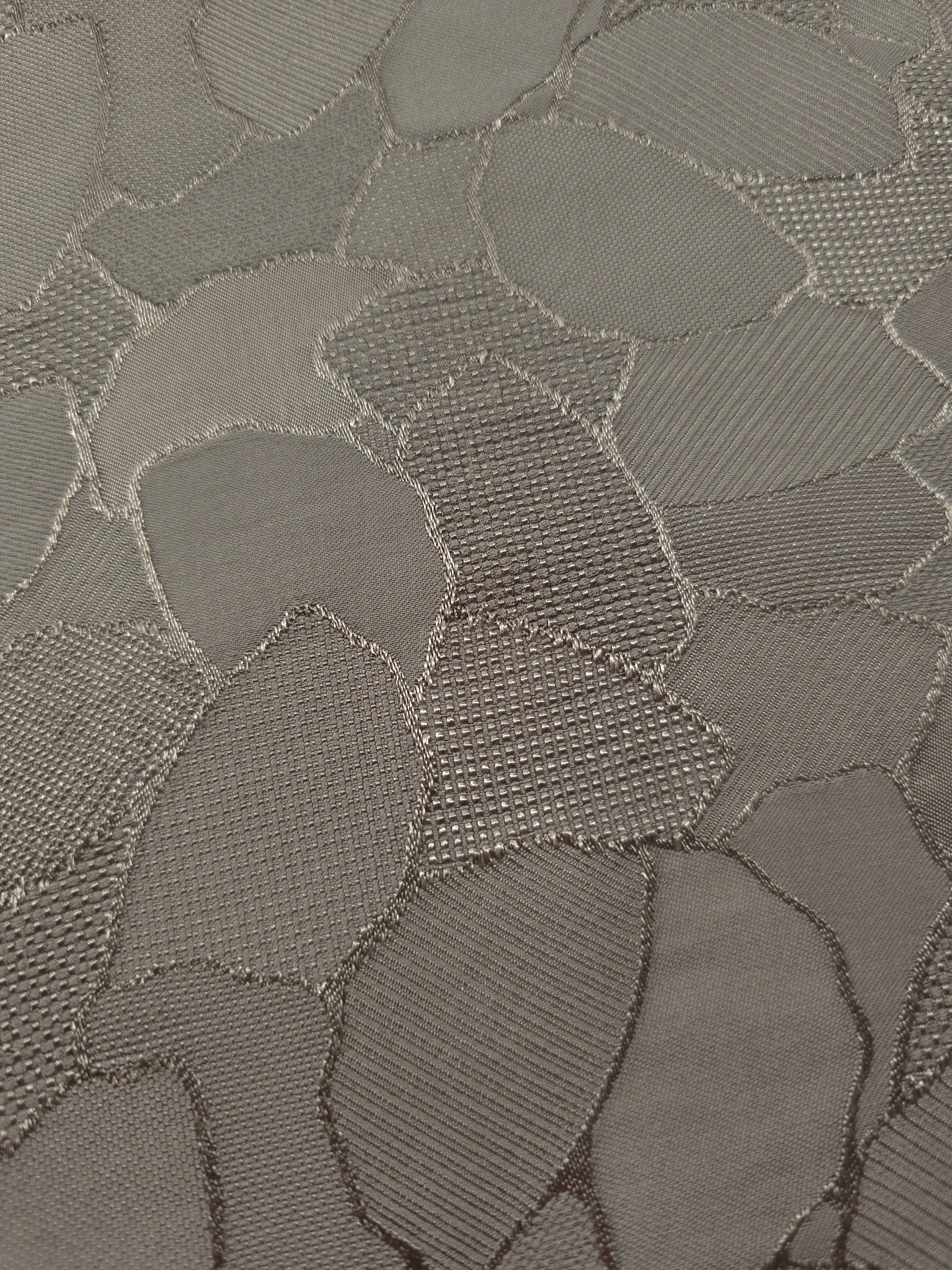 Close-up of tonal mosaic jacquard showing square-weave surface detail.