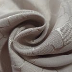 Close drape of mosaic square-weave jacquard showing fold detail and soft sheen.