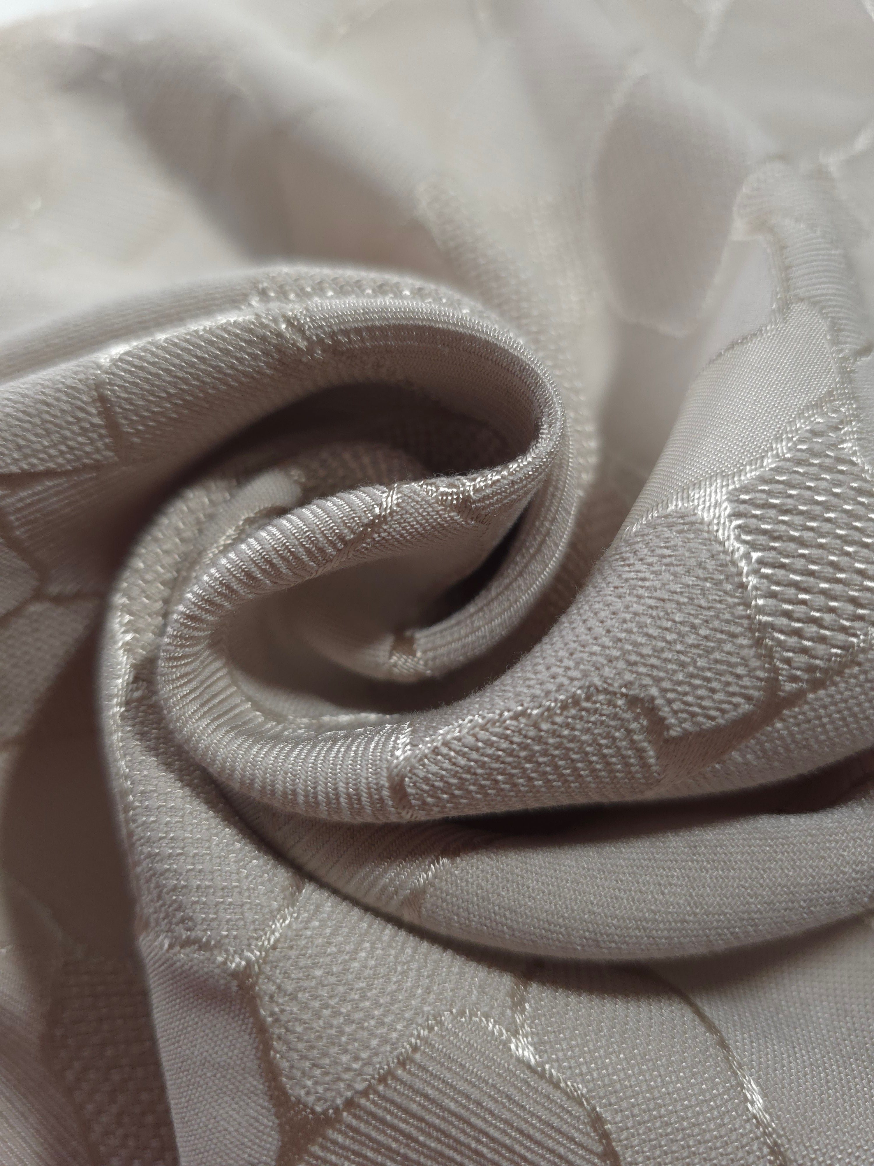 Close drape of mosaic square-weave jacquard showing fold detail and soft sheen.