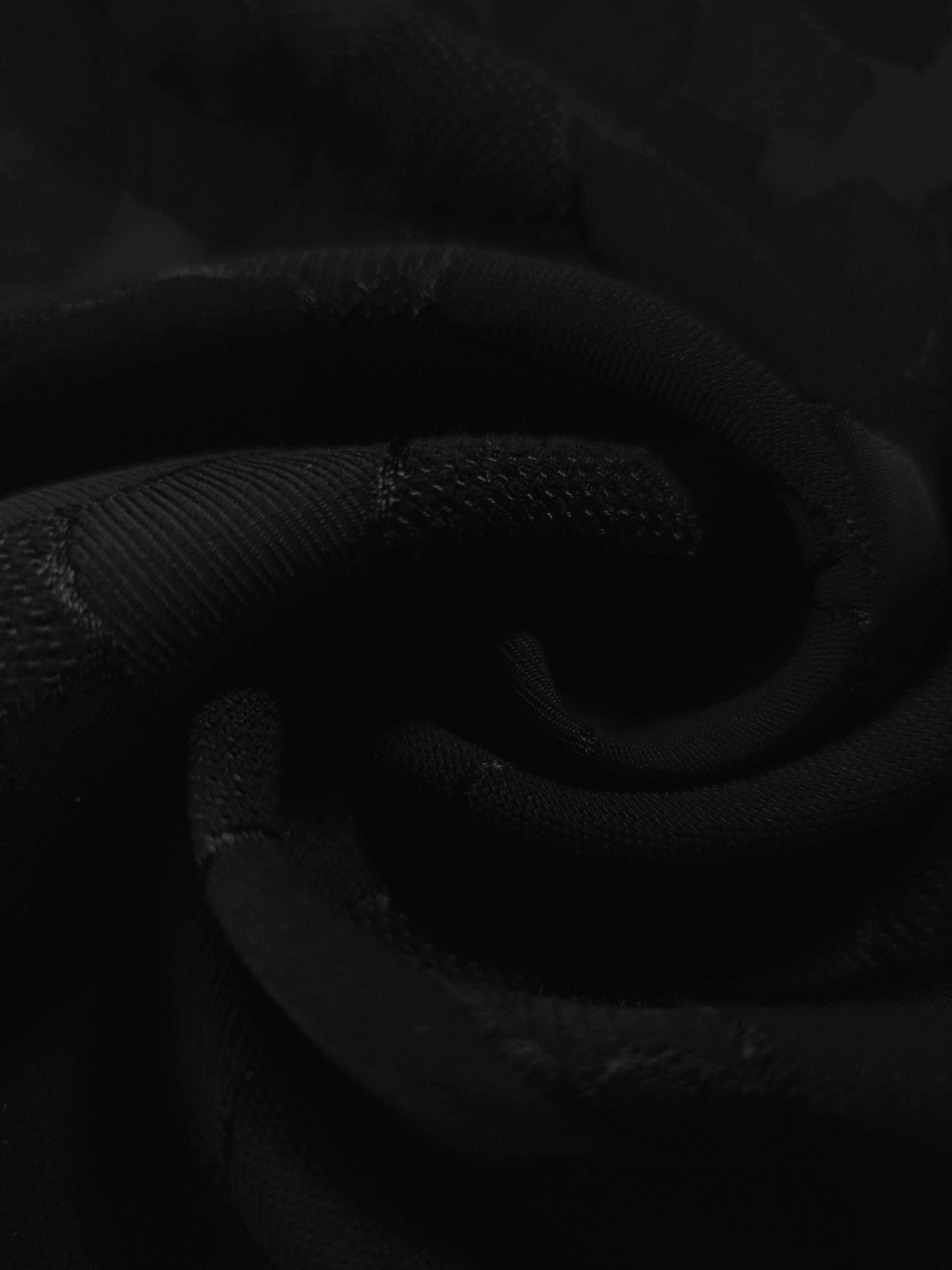 Close drape of mosaic jacquard in another colourway showing fold detail.