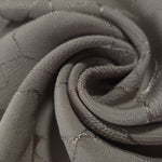 Close drape of tonal mosaic jacquard showing fold detail for sewing.