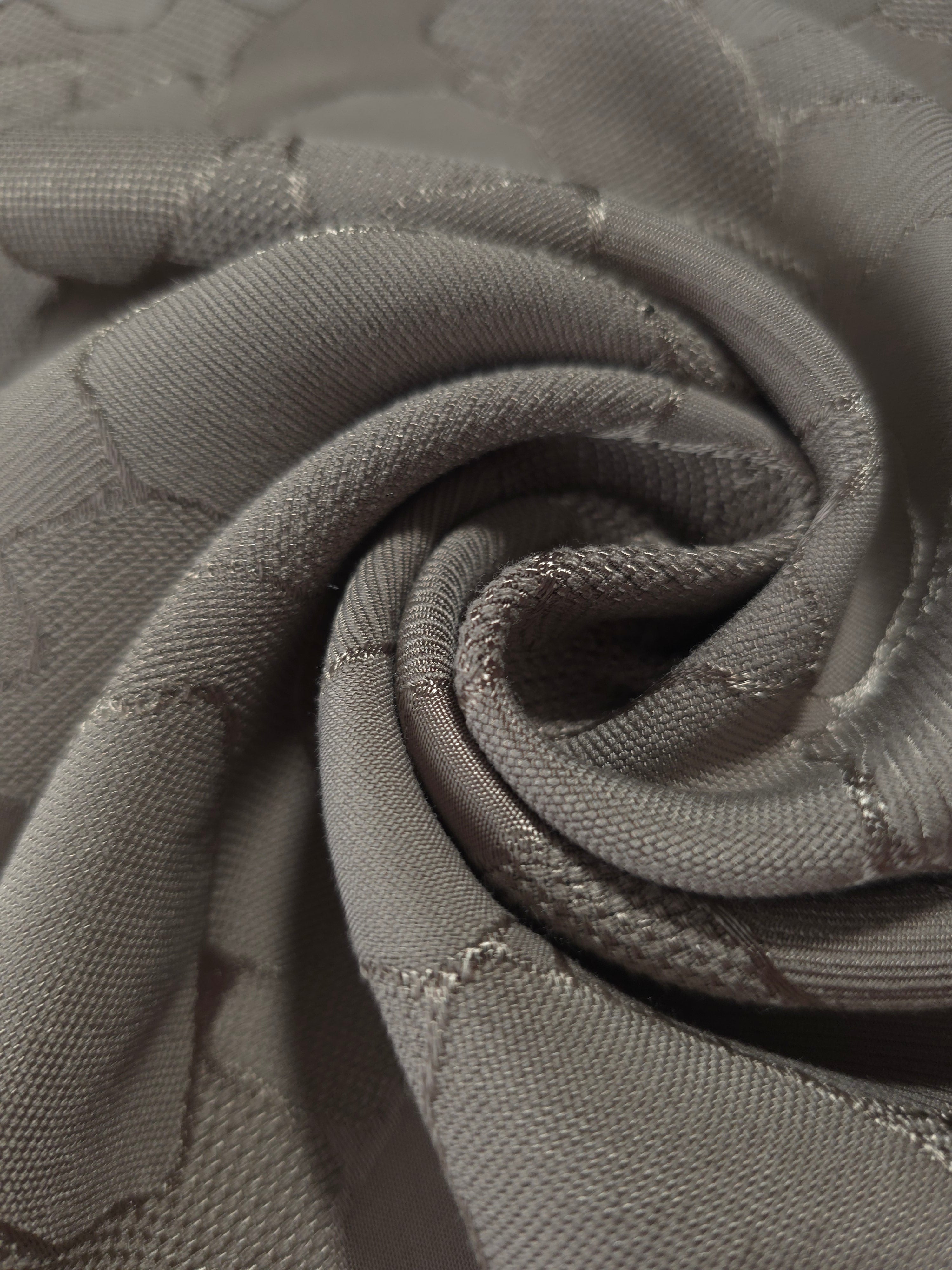 Close drape of tonal mosaic jacquard showing fold detail for sewing.
