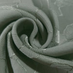 Close drape of mosaic jacquard colourway showing soft folds and sheen.