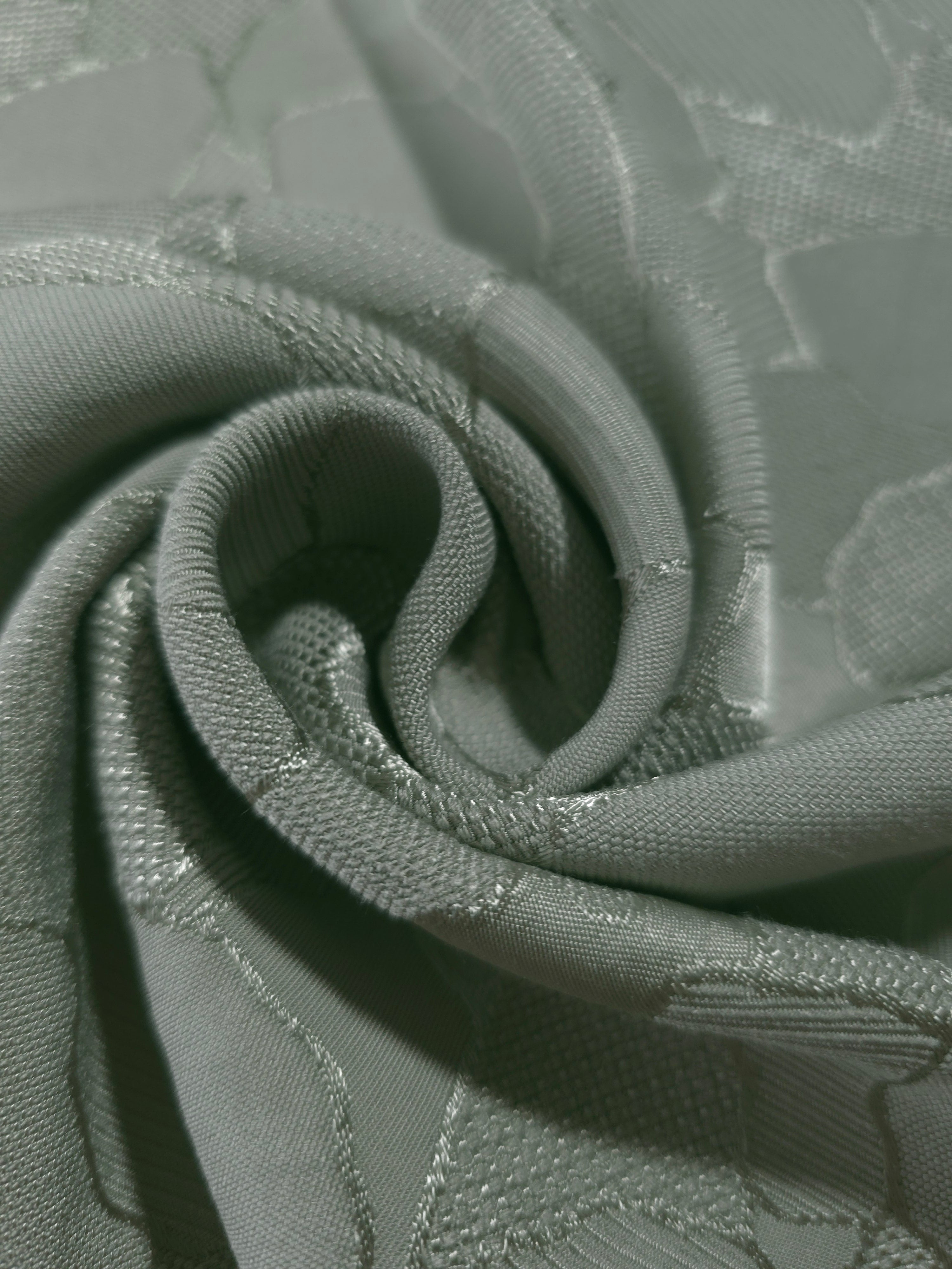 Close drape of mosaic jacquard colourway showing soft folds and sheen.