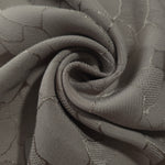 Draped tonal mosaic square-weave jacquard with structured fluid fall.