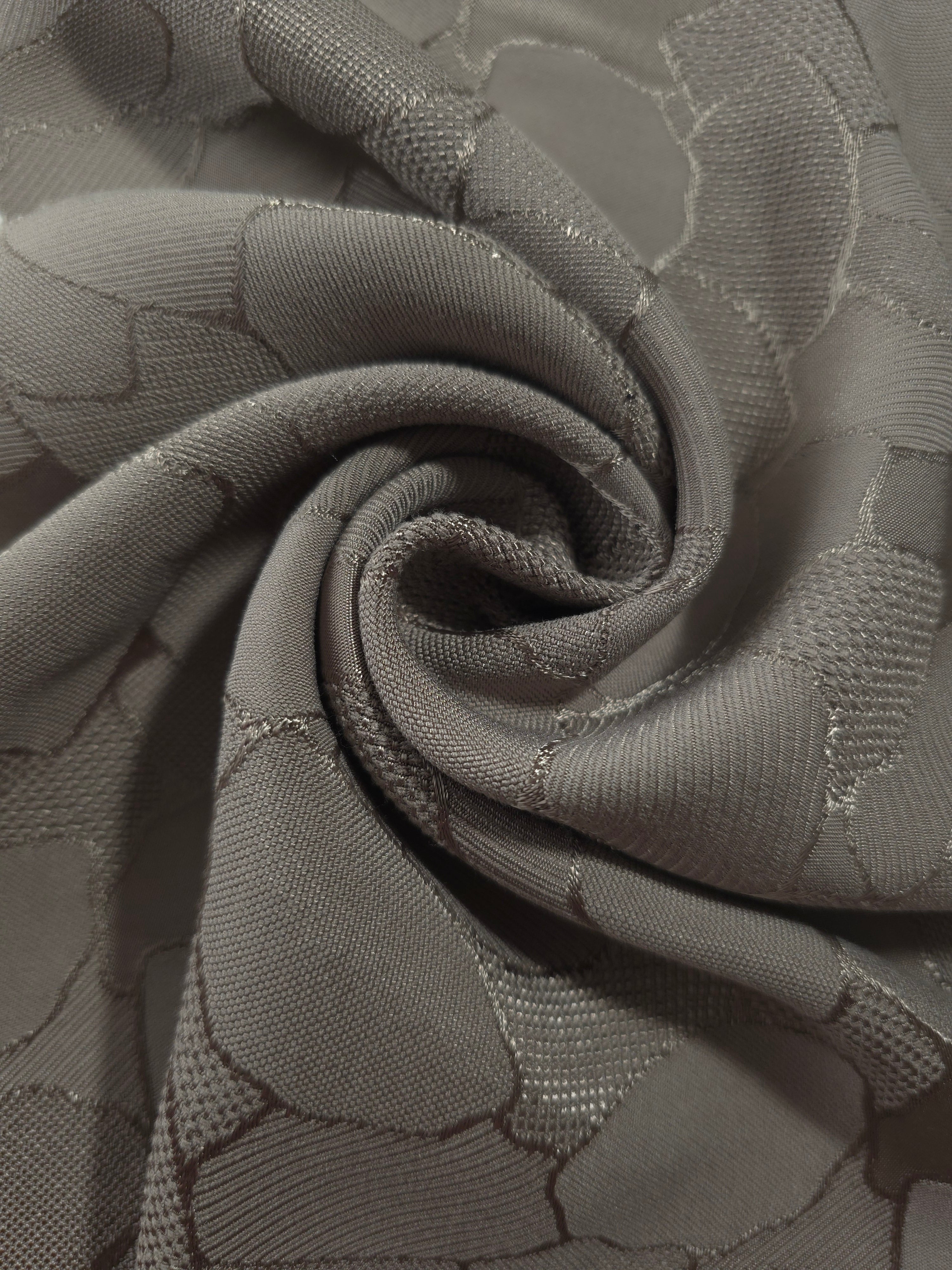 Draped tonal mosaic square-weave jacquard with structured fluid fall.