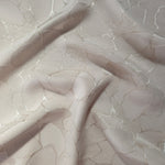 Wave fold of mosaic square-weave jacquard showing satin-on-matte pattern.