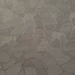 Wide view of tonal mosaic jacquard fabric for dressmaking yardage.