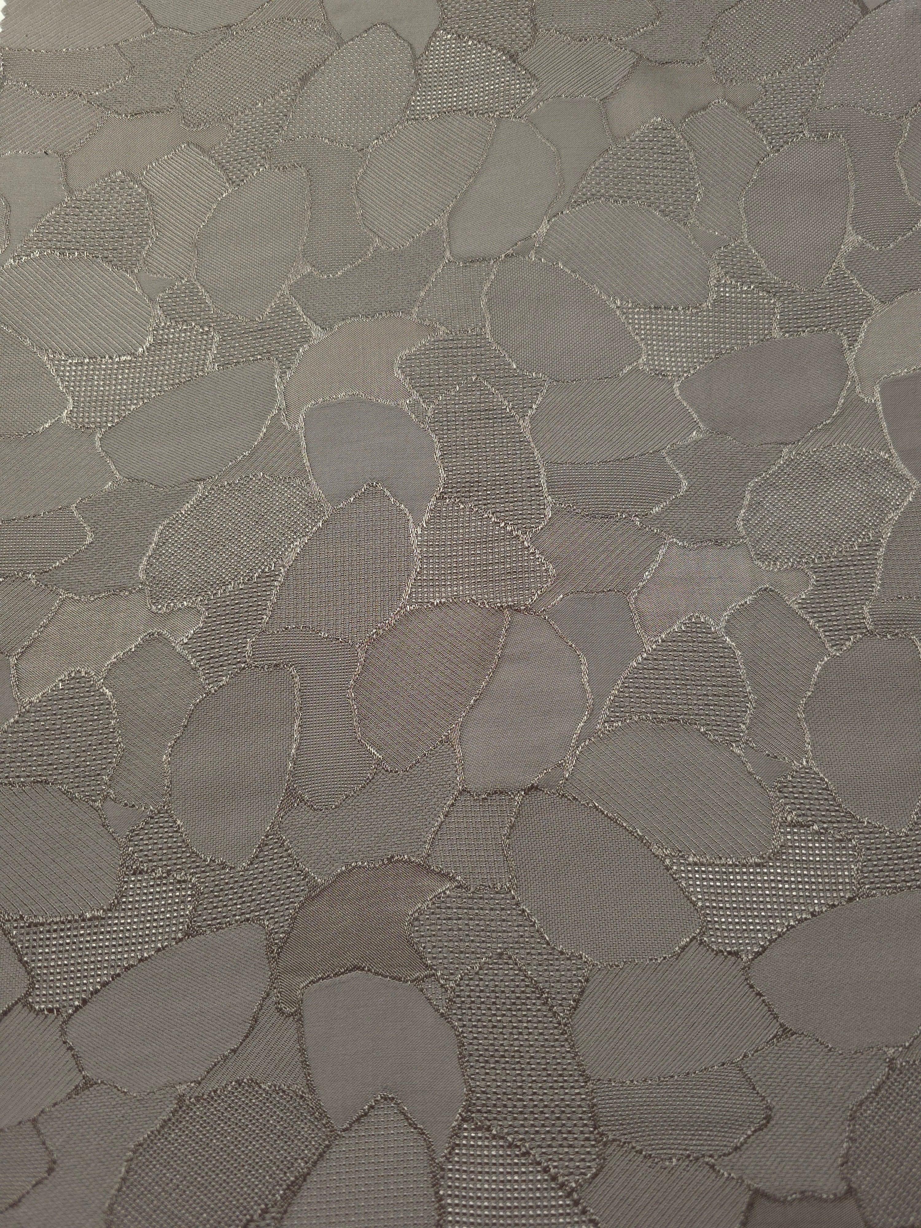 Wide view of tonal mosaic jacquard fabric for dressmaking yardage.