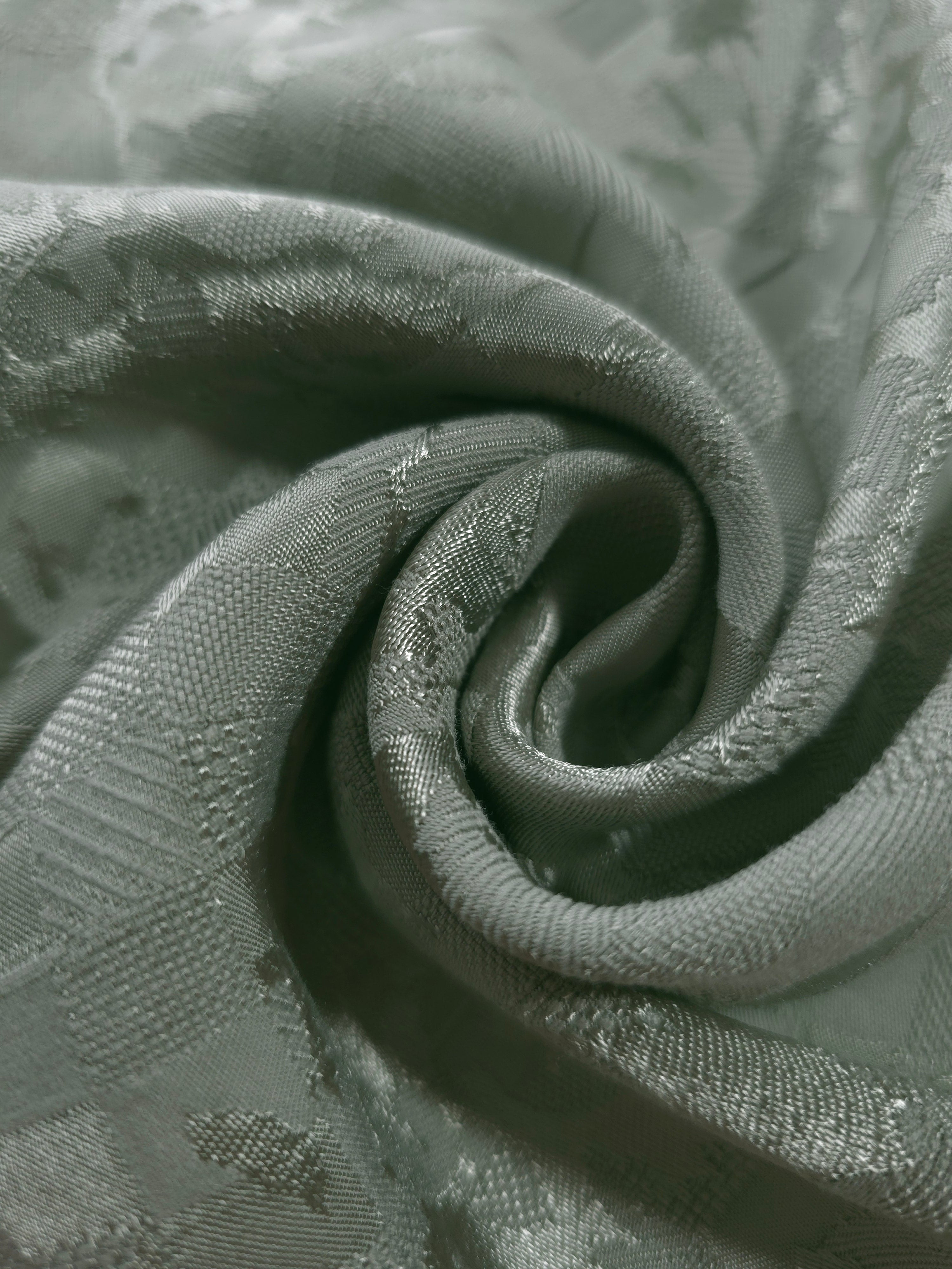 Close drape of splash brick jacquard colourway showing woven fold detail.