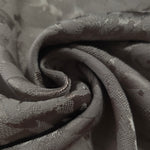 Close drape of tonal splash brick jacquard showing folds and texture.