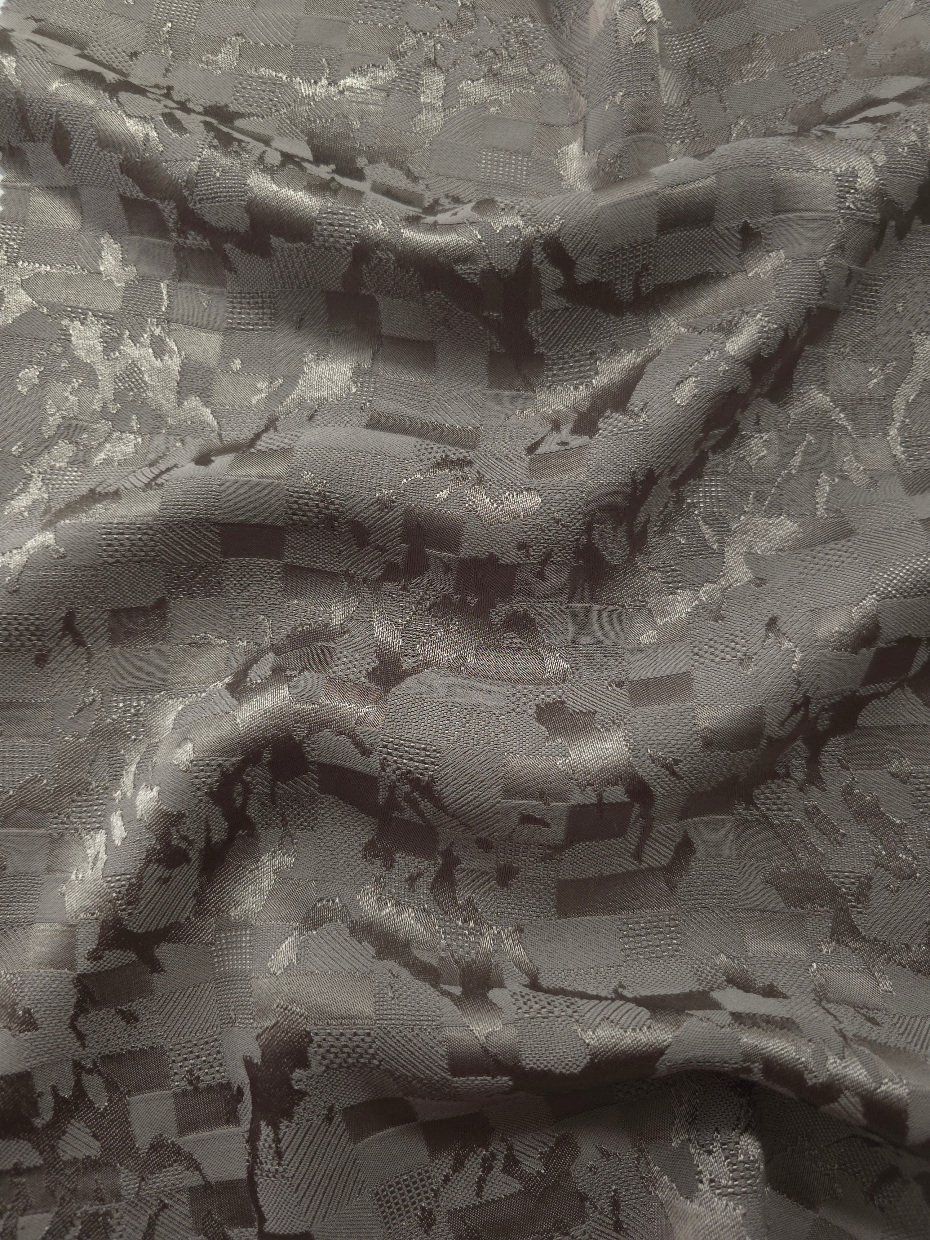Wave fold of tonal splash brick jacquard showing soft woven sheen.