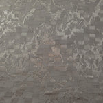 Wide view of tonal splash brick jacquard fabric for garment panels.