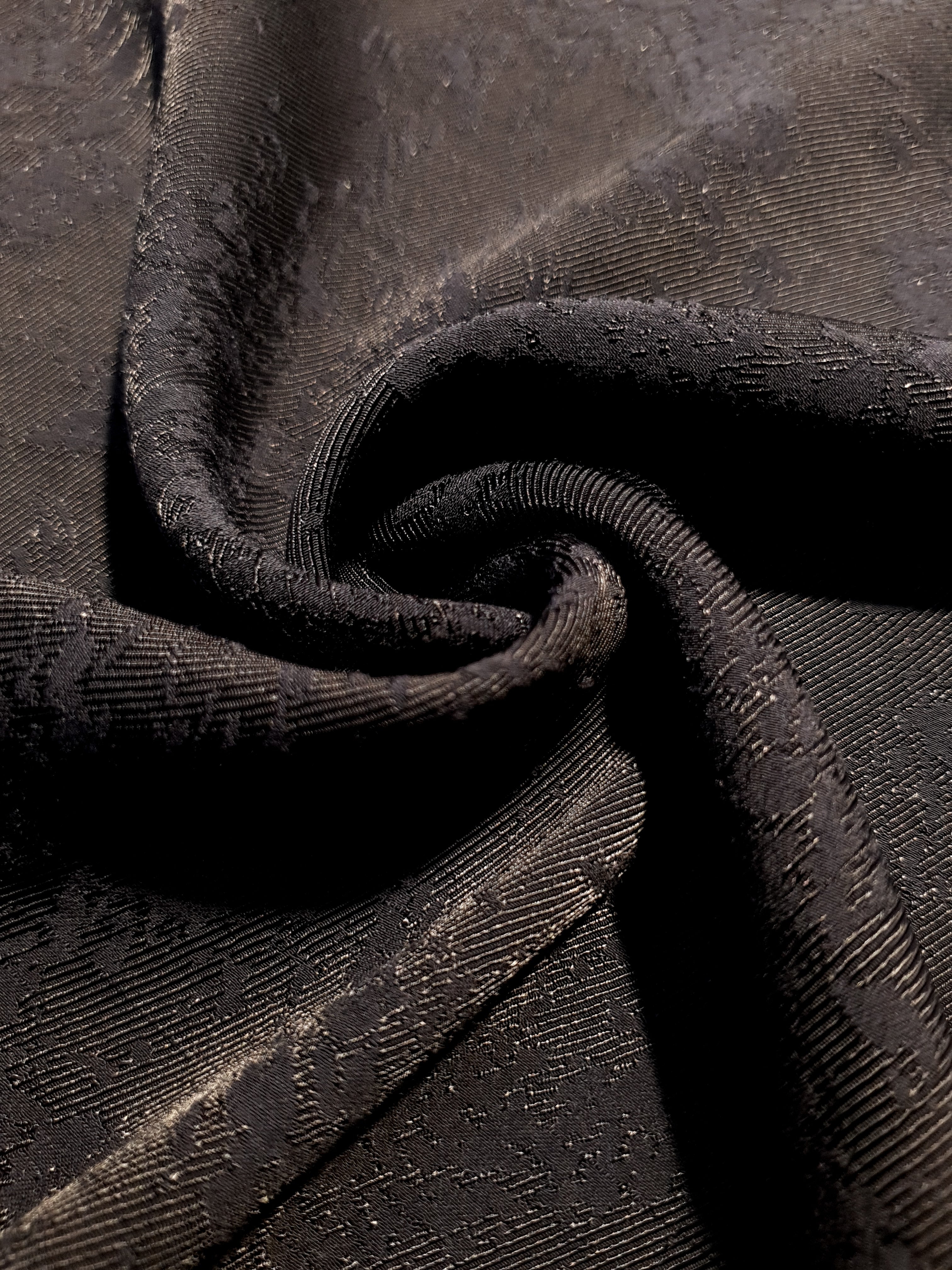 Drape detail of structured animal print jacquard for jackets and skirts.