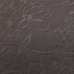 Close detail of structured floral jacquard with woven rayon surface.
